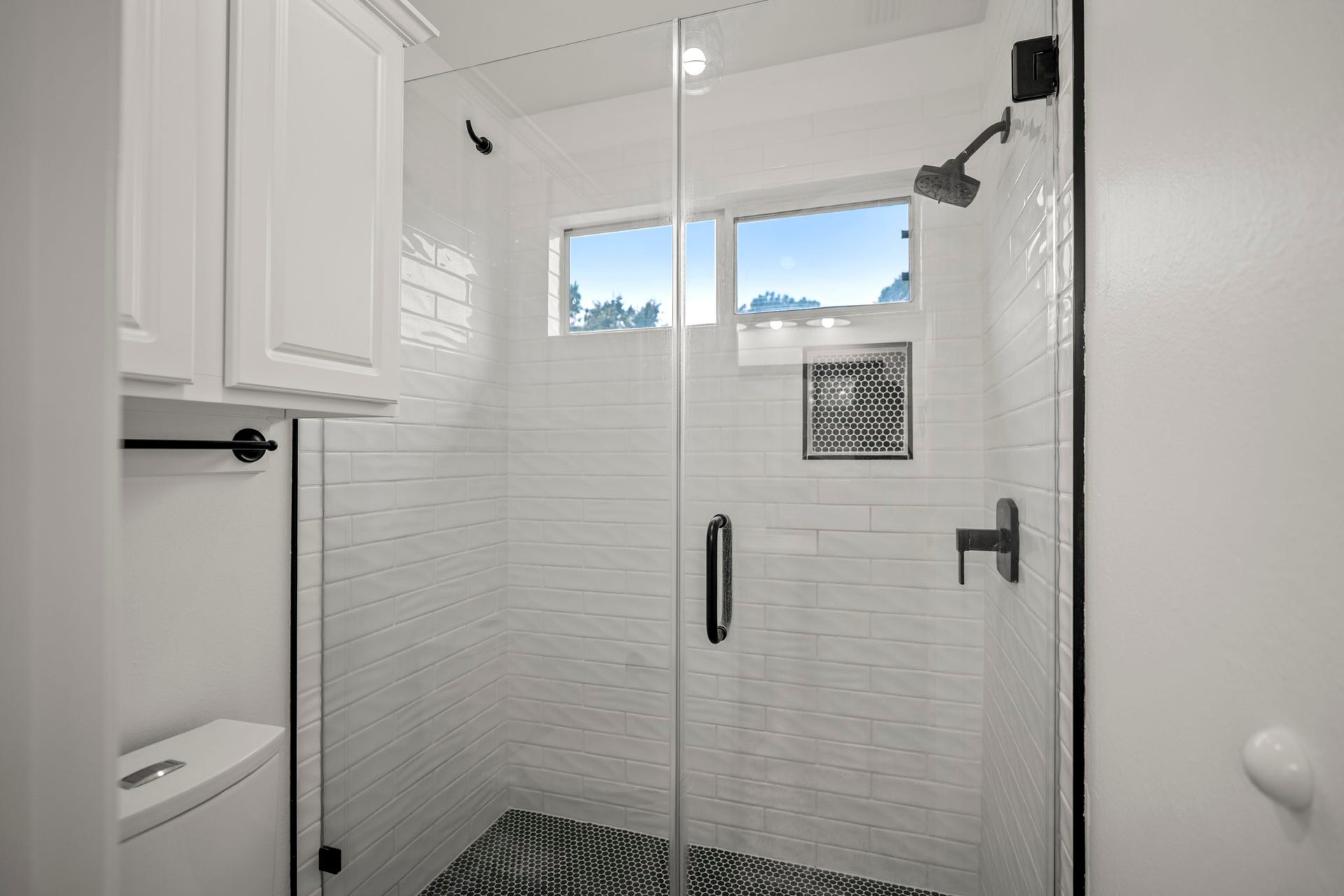 The upstairs bathroom has a fully glass enclosed shower and has been updated to be modern in design.