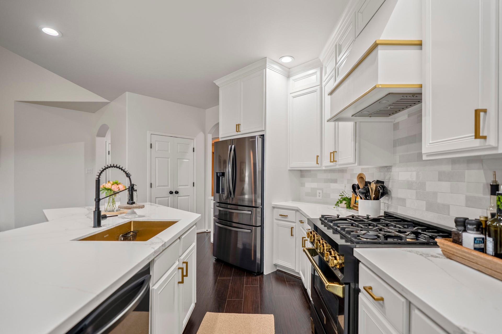 The kitchen has been updated and features quartz countertops, a ZLINE four-burner gas range, double ovens & wine fridge.