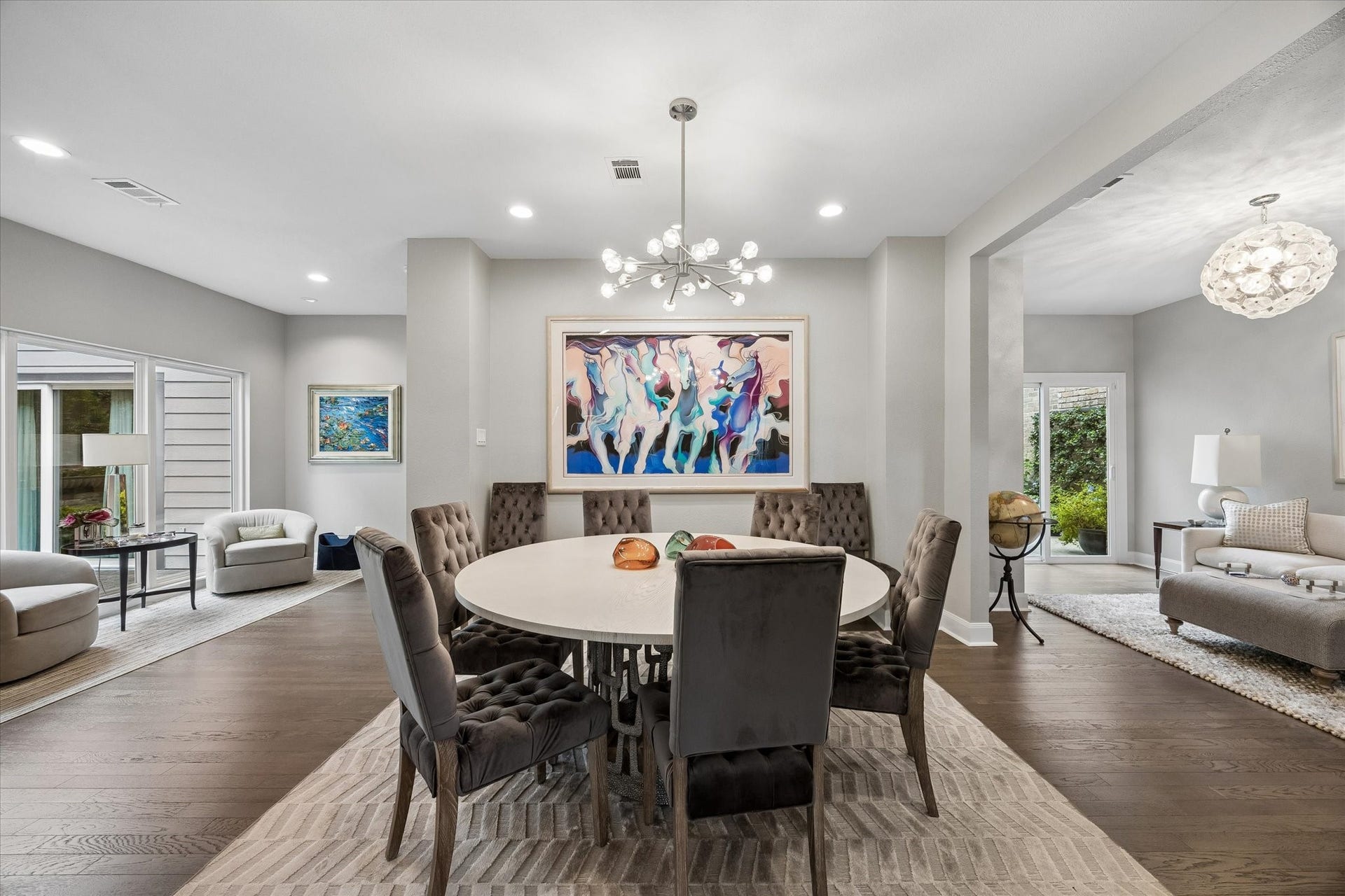 DINING ROOM: Elegant dining room showcases hardwood flooring, contemporary lighting and an open layout connecting the surrounding living spaces.