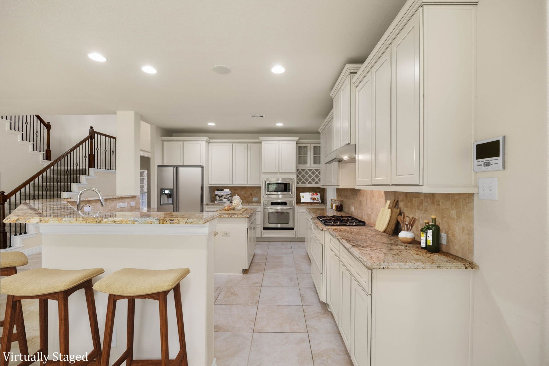26306 Sunny Springs Lane, Cypress, TX 77433 Large, open kitchen with walk-in pantry and an island with storage, abundant cabinetry, granite countertops, recessed lighting, built-in appliances, wine rack, and generous counter space for meal preparation and entertaining.