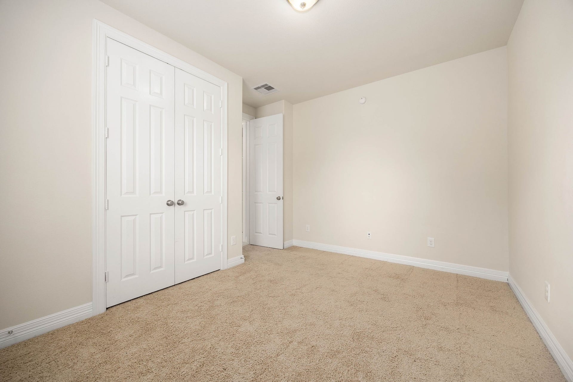26306 Sunny Springs Lane, Cypress, TX 77433 First floor secondary bedroom features a double-door closet.