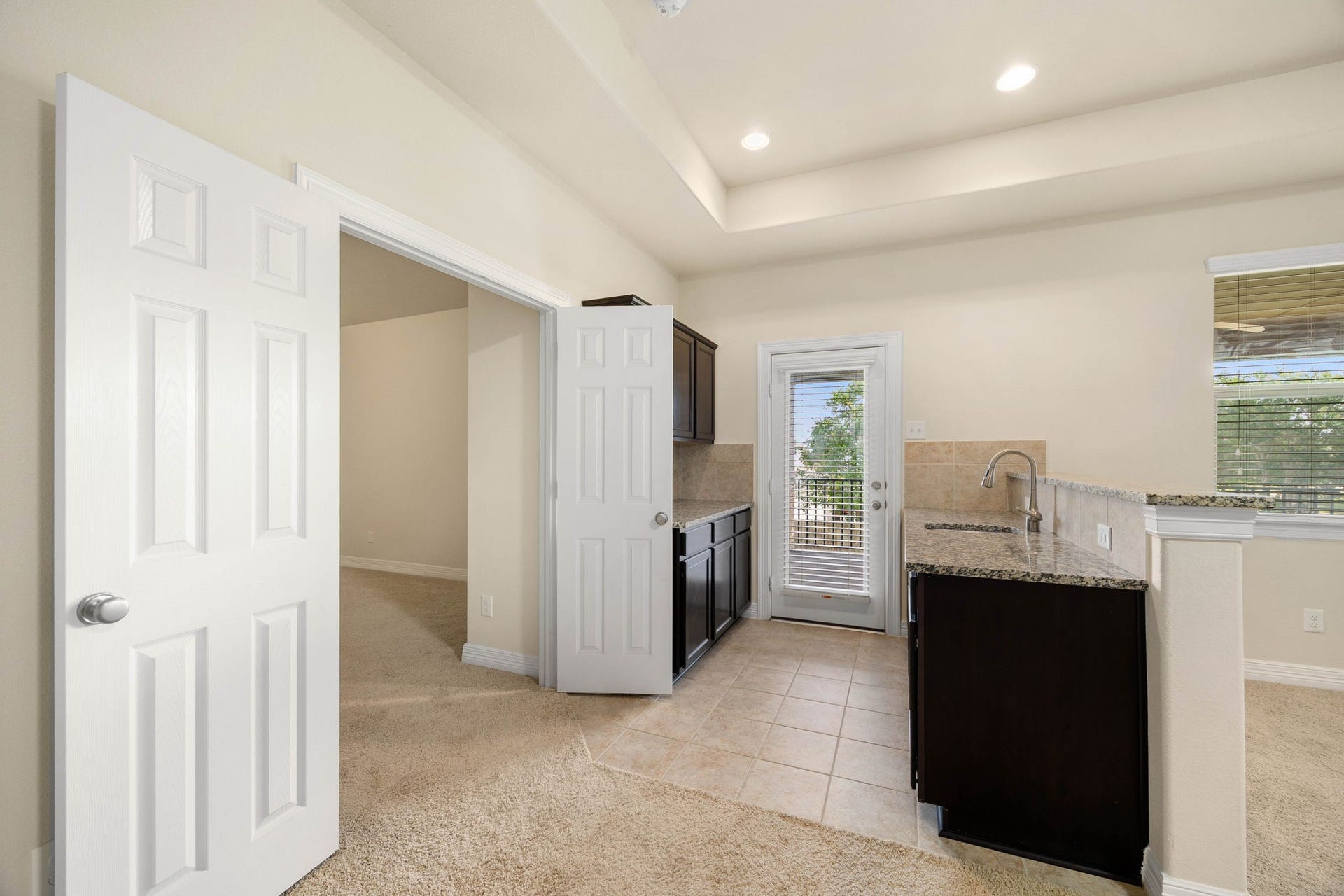 26306 Sunny Springs Lane, Cypress, TX 77433 Entertain with ease from the convenient upstairs kitchenette featuring ample cabinetry, counter space, and a sinkperfectly positioned to serve the game room, nearby media room, and outdoor covered deck area.