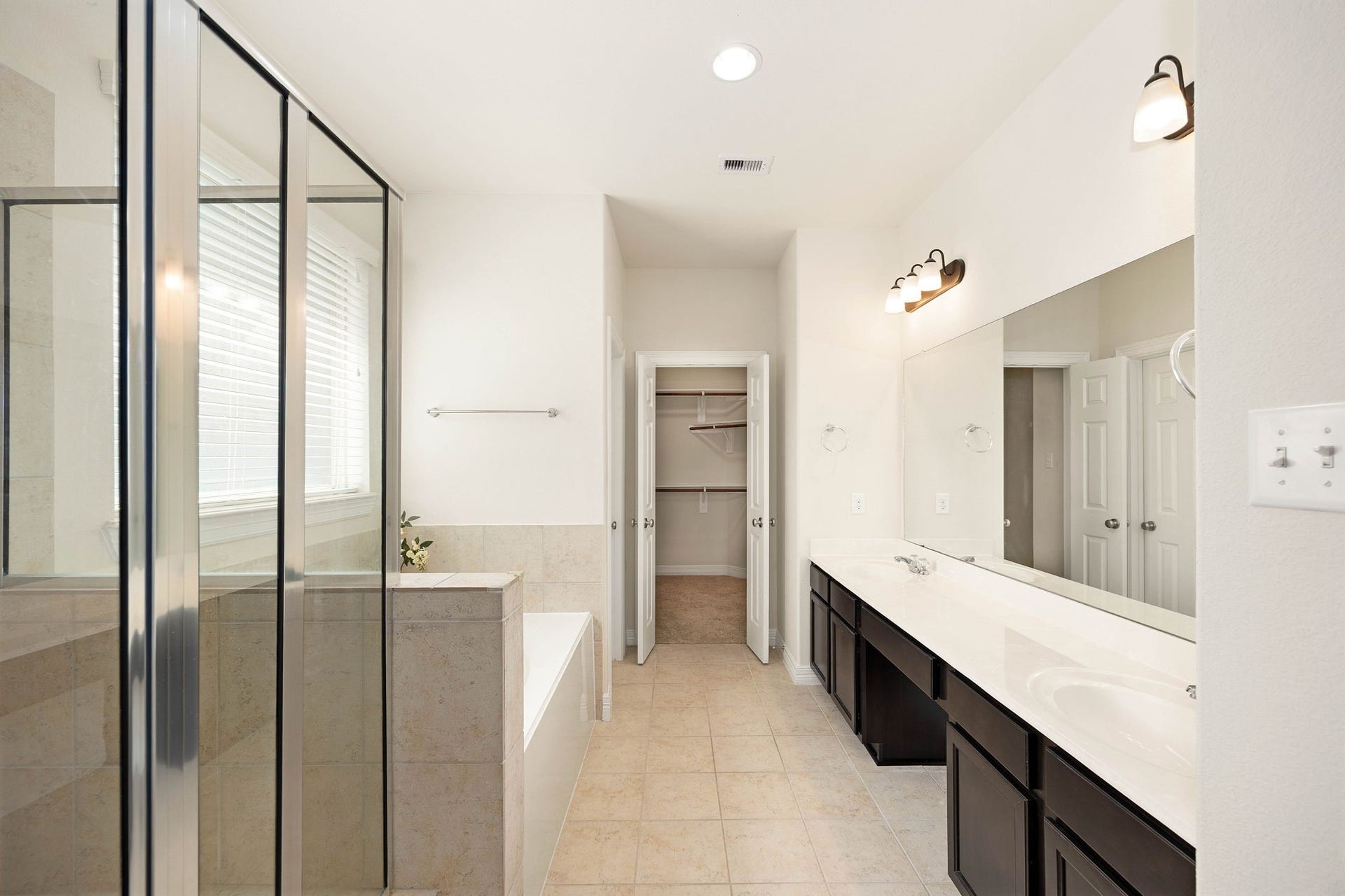 26306 Sunny Springs Lane, Cypress, TX 77433 Private en-suite bath features a double sink vanity with abundant counter and cabinet space, separate shower, soaking tub, and walk-in closet.