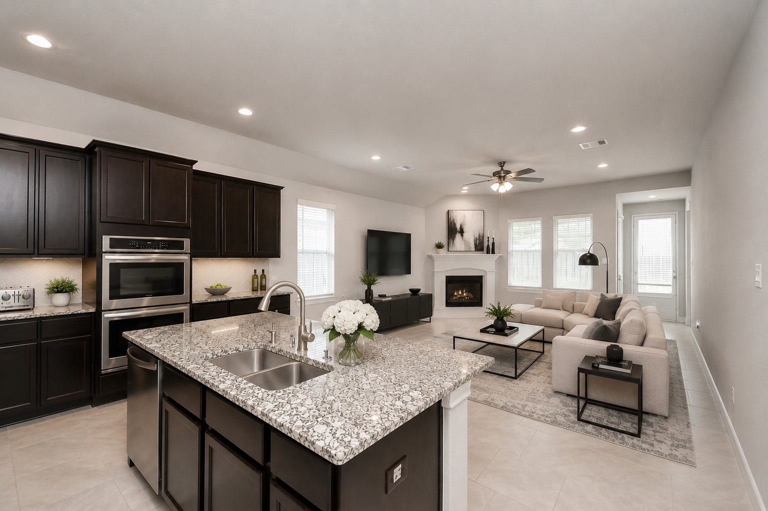 1026 Warm Summer Drive, Richmond, TX 77406 Kitchen offers extensive prep space, breakfast bar seating, and seamless flow into the living area. Refrigerator included. *Virtually staged*