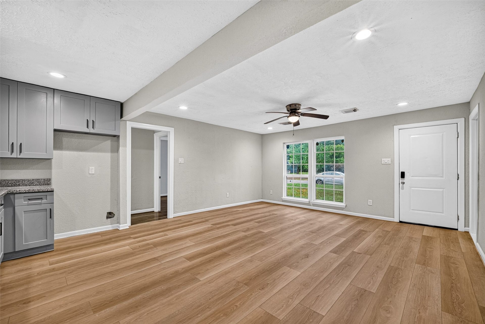 The room touts its wood vinyl plank floors and open concept.