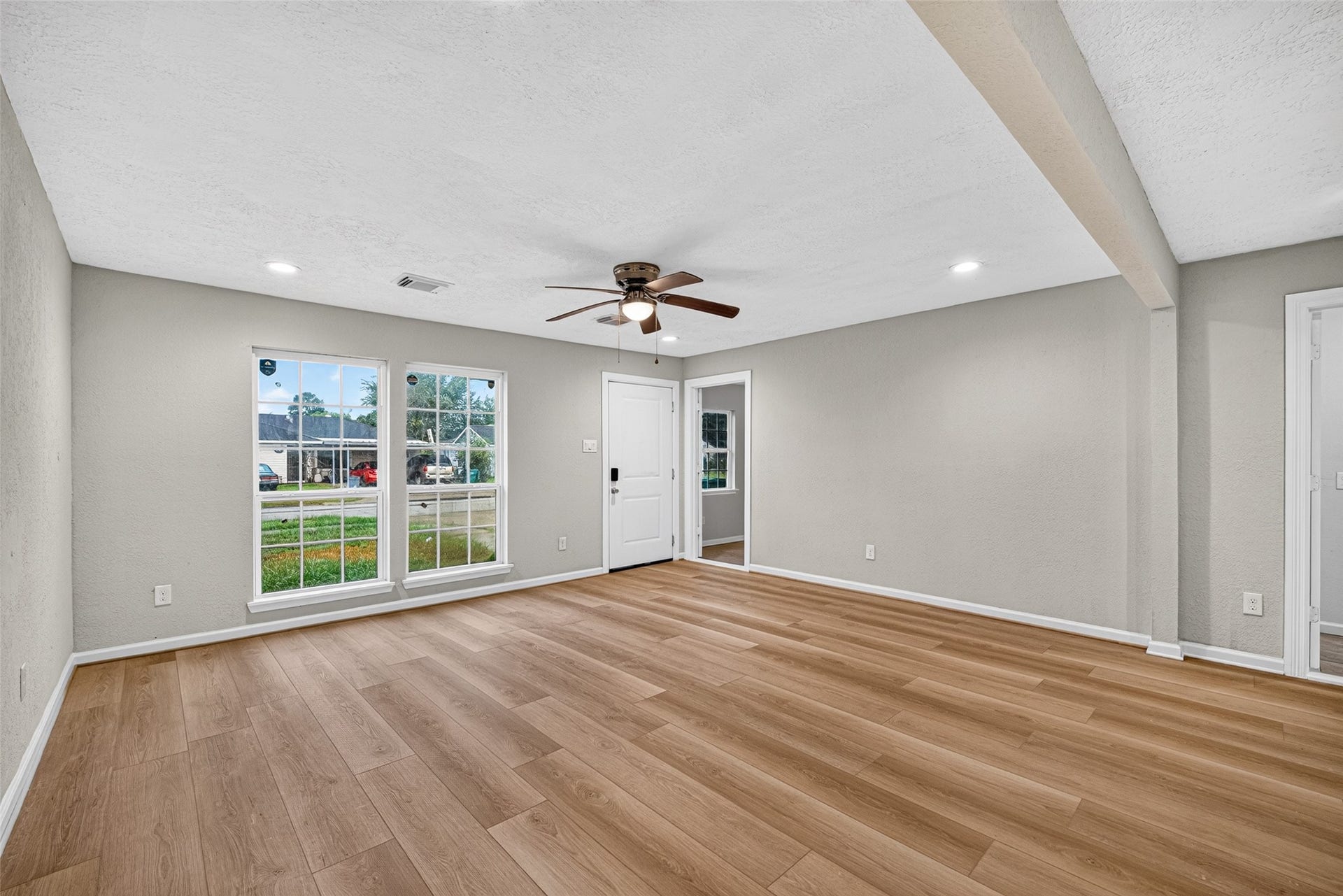 The room has great natural light plus recessed lighting and a ceiling fan.