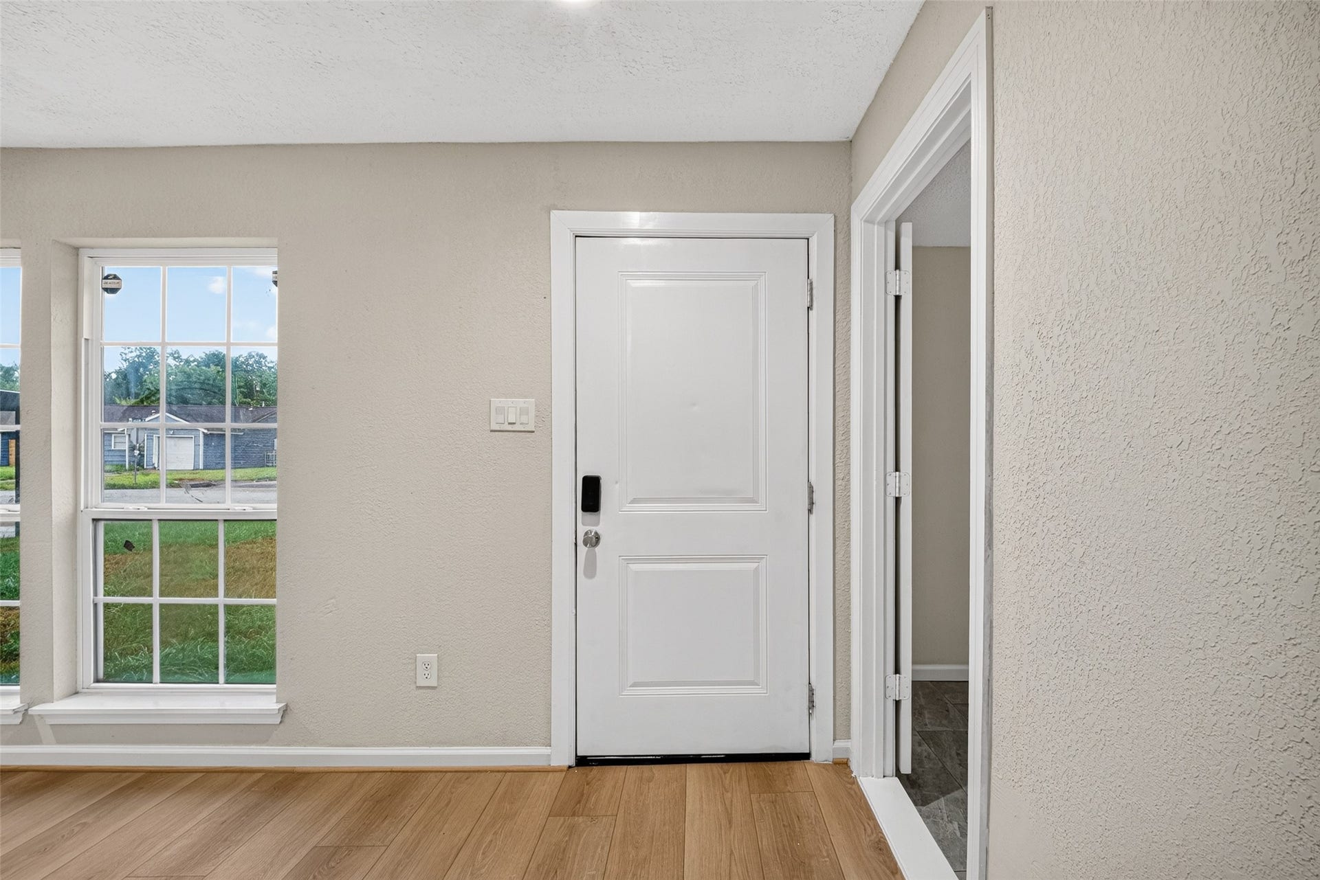 Entry into the room is enhanced by natural light through large double paned windows.