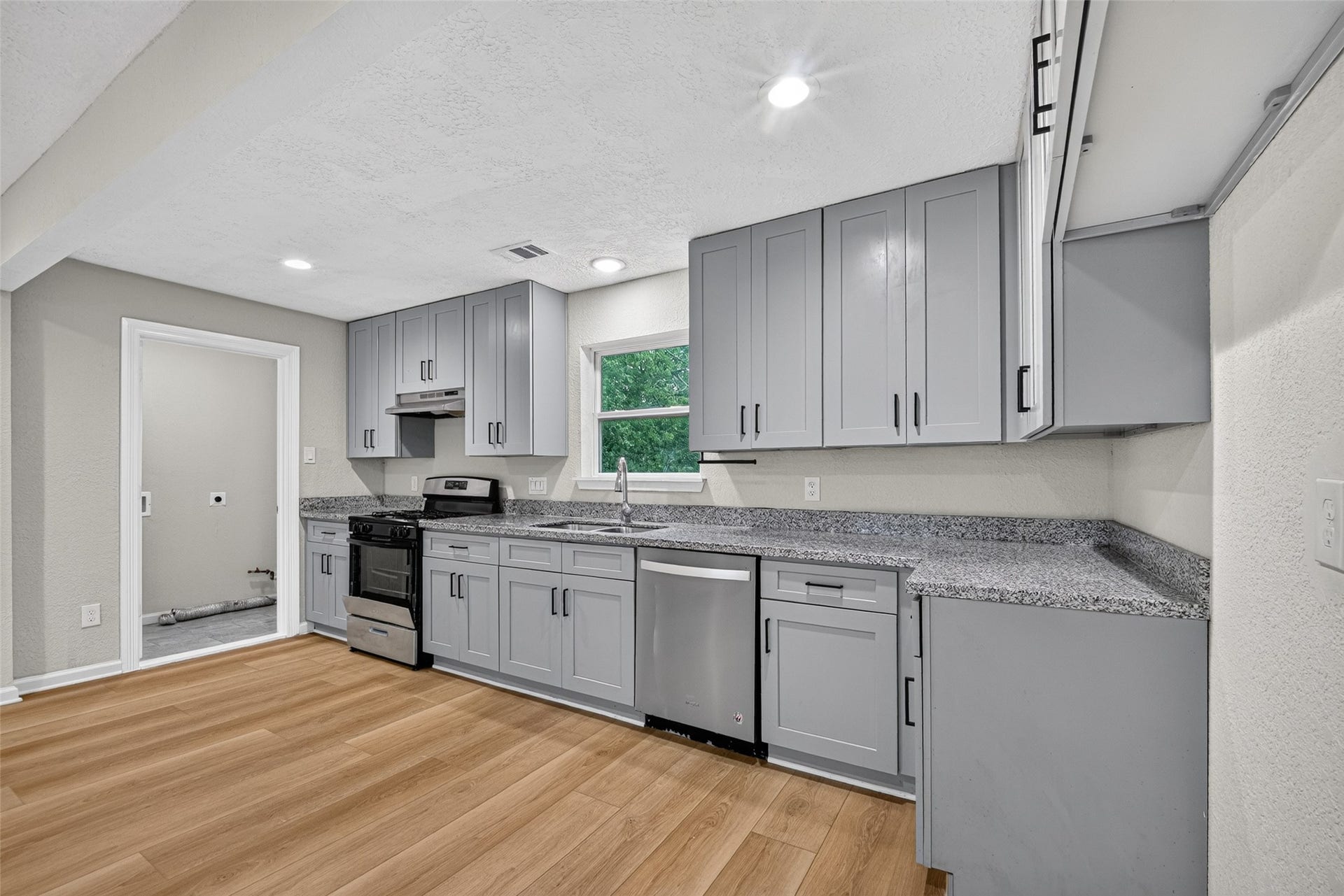 Laundry room and exit to back yard is just off the kitchen.