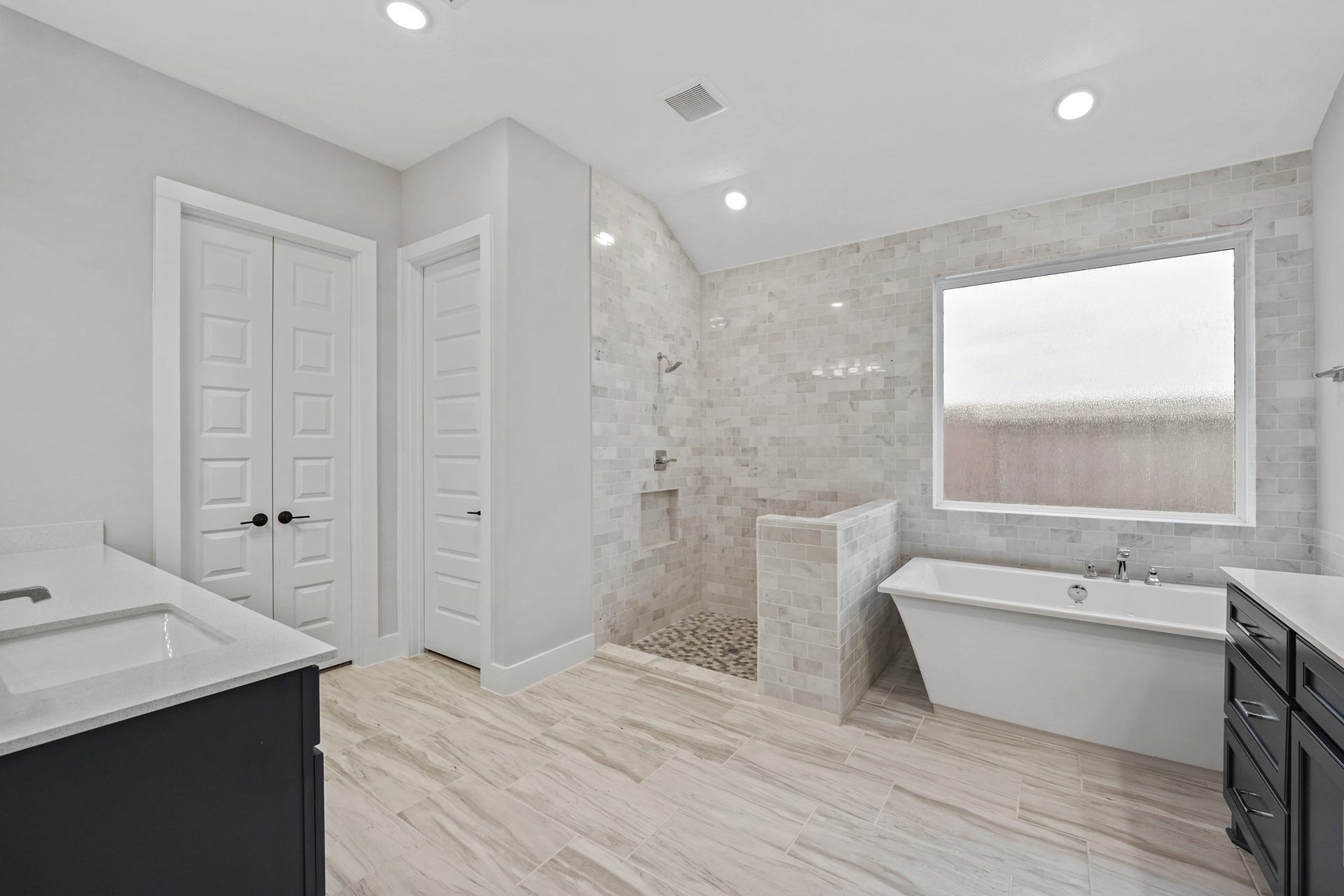 Primary bathroom suite! The shower glass frame is installed, the picture was taken prior to installation.