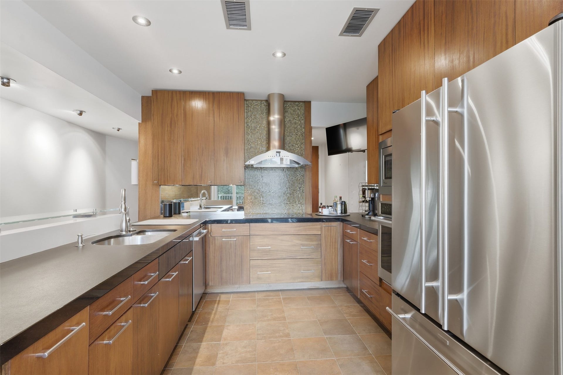Renovated kitchen has tons of storage, lighting, and upgraded appliances.