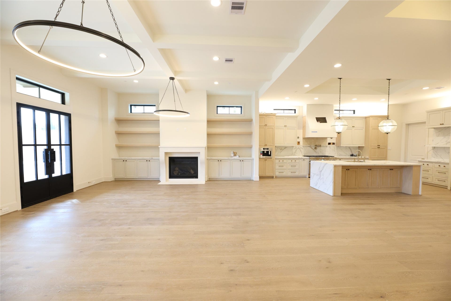 752 W 43rd Street, Houston, TX 77018 Family Room offers gas fireplace, custom built-ins w/ floating shelves and transom windows.