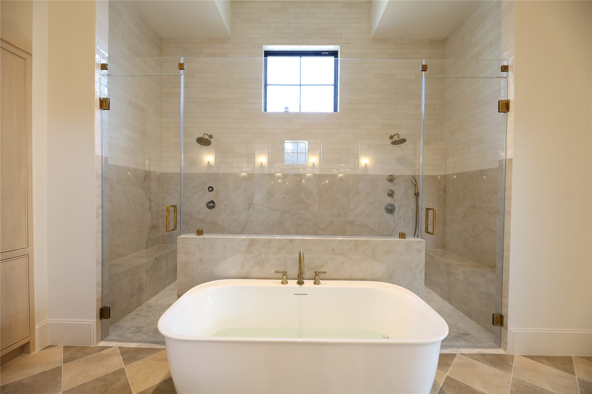 752 W 43rd Street, Houston, TX 77018 Gorgeous tall walk-in shower w/ pony wall, dual fixtures and tile to the ceiling. Soak Tub to be in installed.