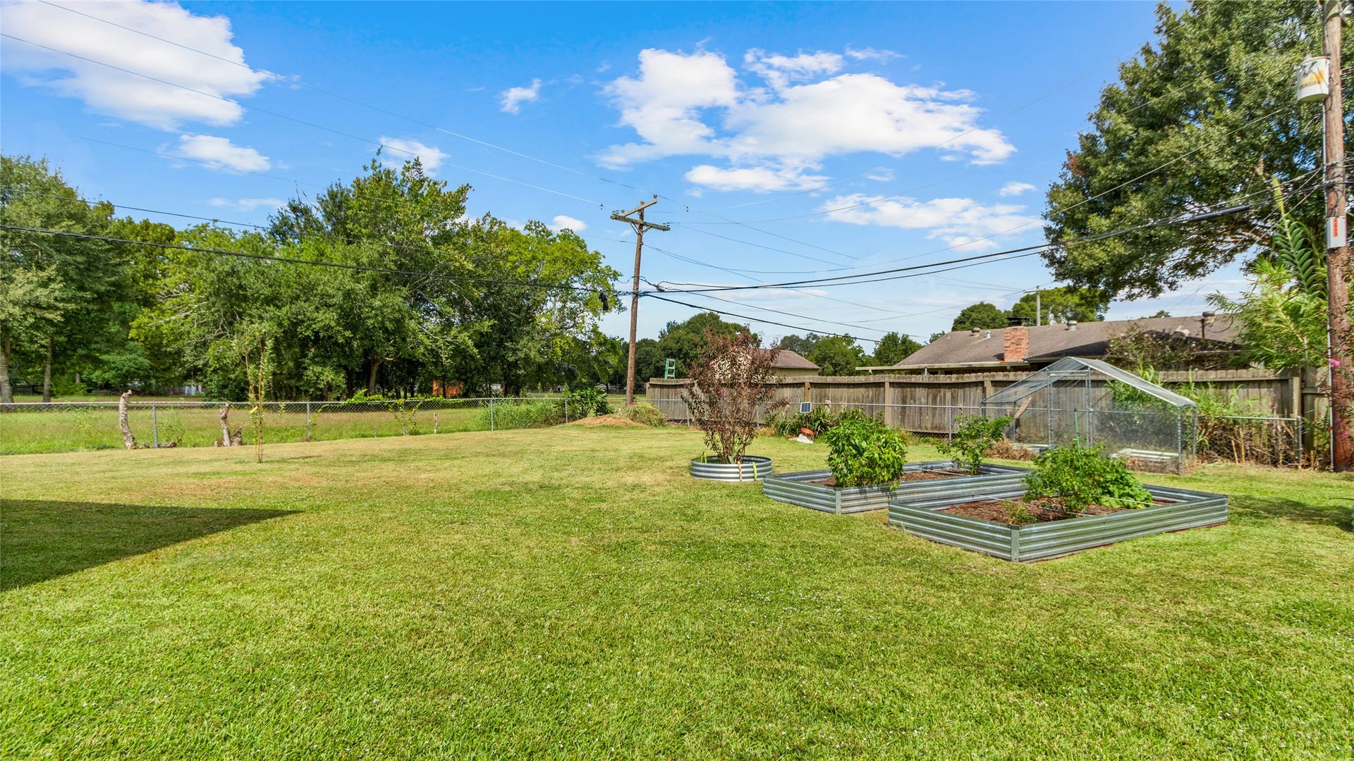 503 Allen Court, Alvin, TX 77511 Expansive backyard offers plenty of open green space along with established raised garden beds and a greenhouseideal for gardening, outdoor activities, or creating your own backyard retreat.