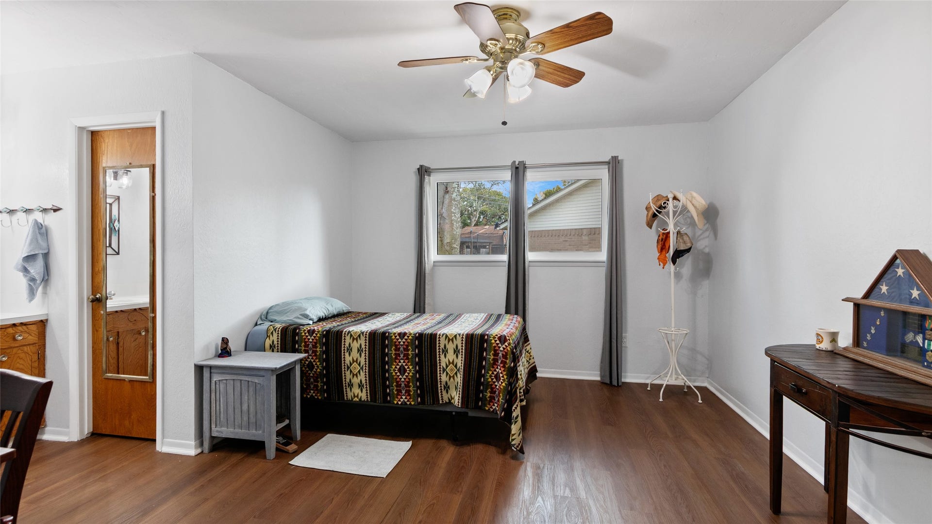 503 Allen Court, Alvin, TX 77511 Generously sized bedroom features wood-look flooring, a ceiling fan, ample wall space, and convenient access to the adjoining bath.