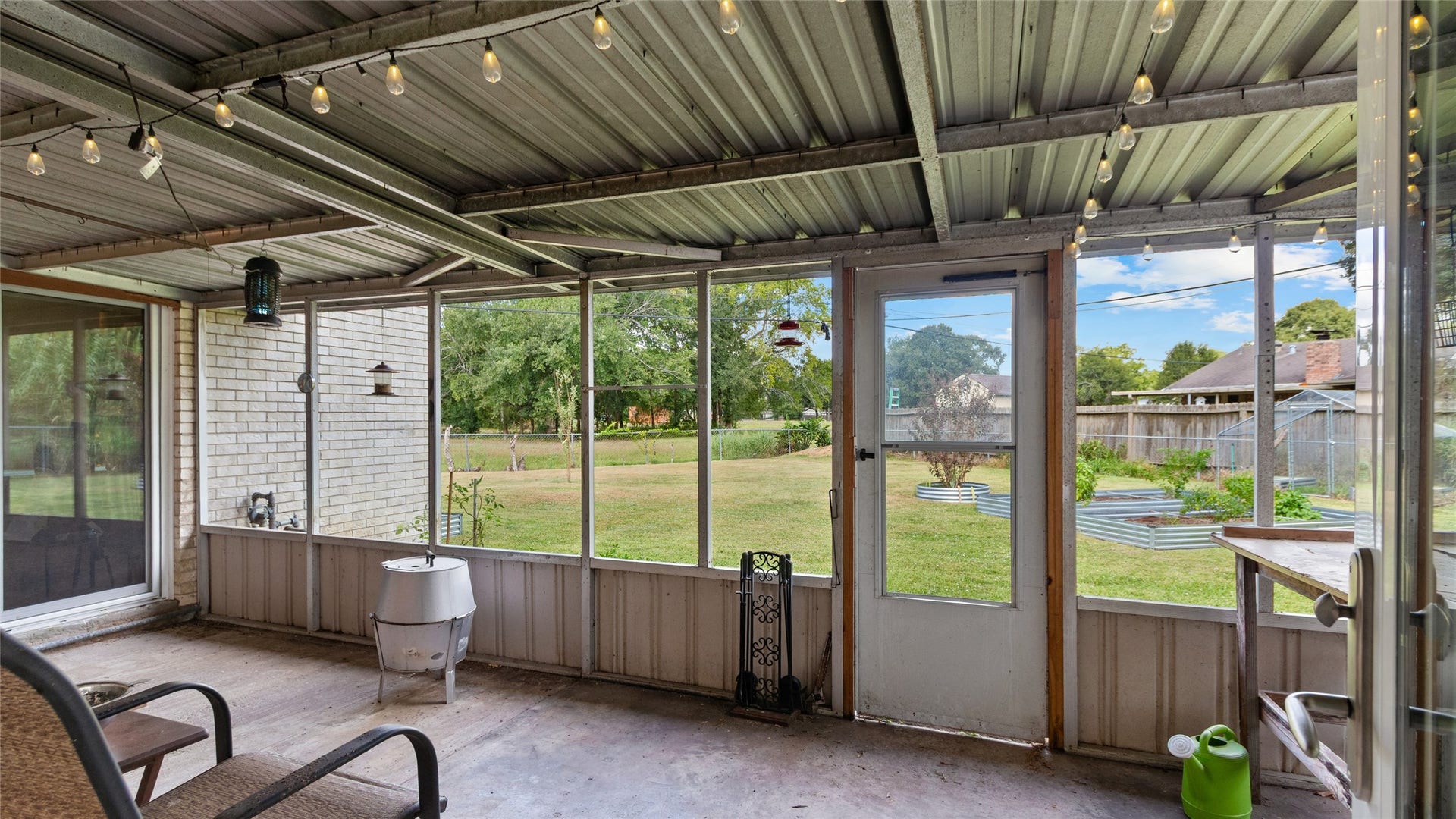 503 Allen Court, Alvin, TX 77511 Expansive covered and screened patio extends the living space outdoors, offering a shaded spot to relax or entertain while overlooking the large backyard.