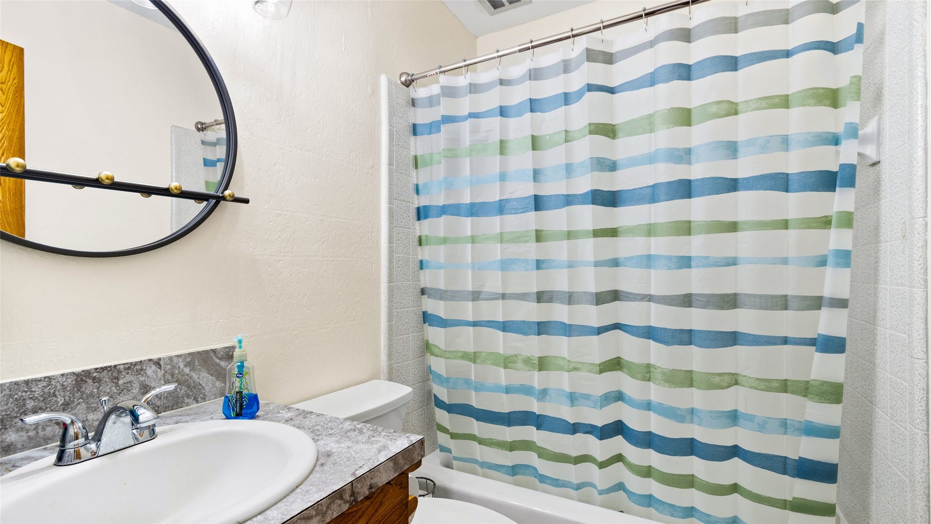 503 Allen Court, Alvin, TX 77511 Secondary full bathroom features a tub/shower combination with tiled surround, generous vanity counter space, and a clean, functional layout.