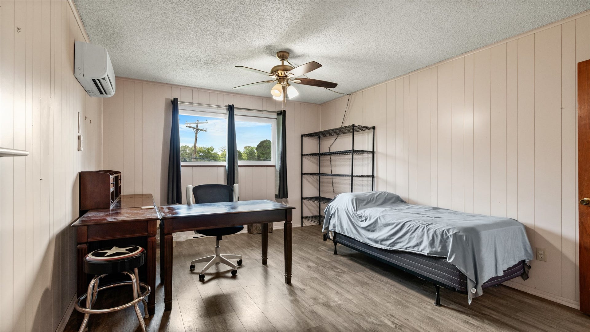 503 Allen Court, Alvin, TX 77511 Generously sized secondary bedroom offers abundant natural light, wood-look flooring, a ceiling fan, and plenty of flexibility for a bedroom, home office, or multipurpose space.