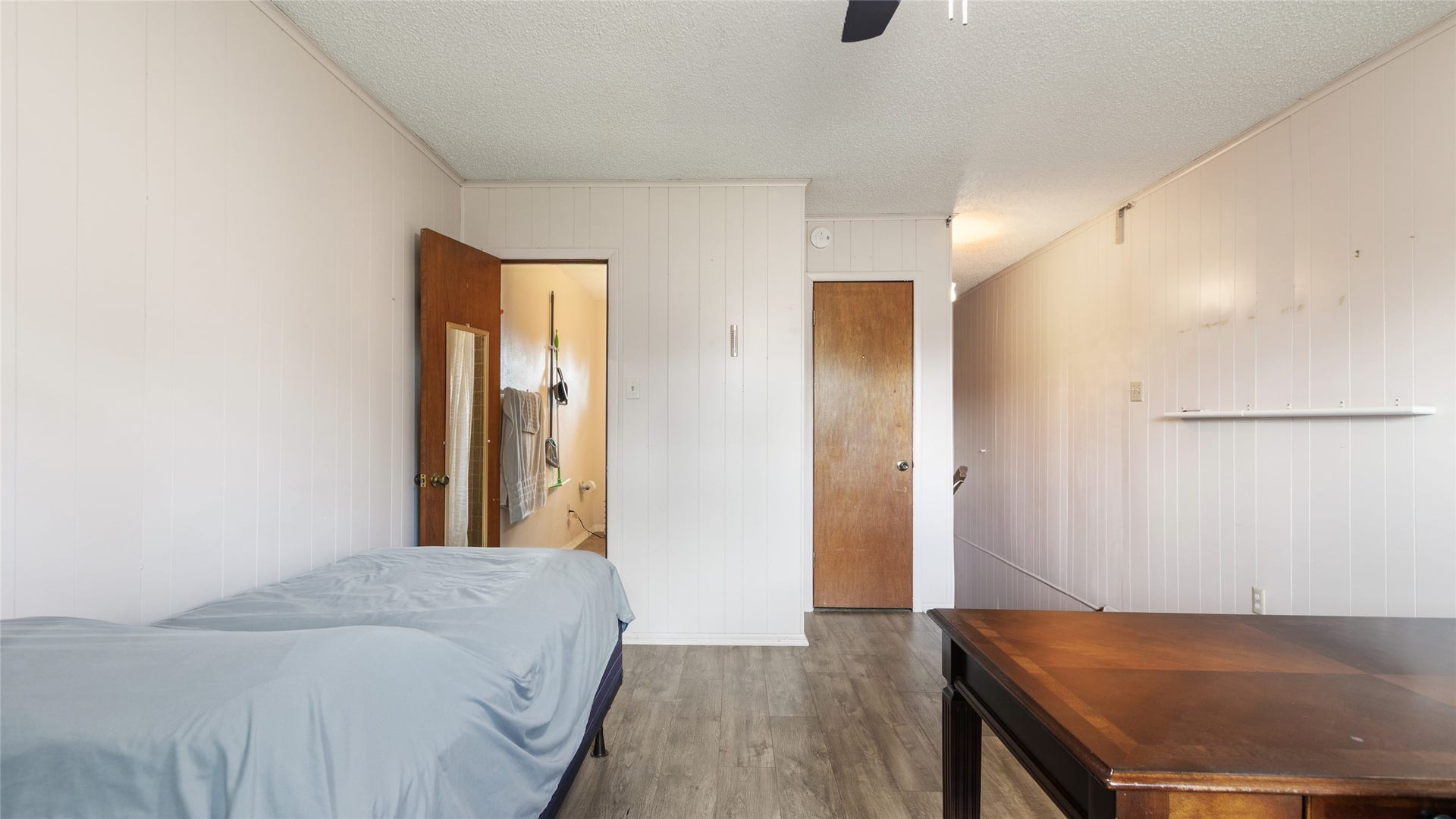 503 Allen Court, Alvin, TX 77511 Another view of the generously sized secondary bedroom, highlighting the flexible layout, wood-look flooring, and convenient access to the adjoining bathroom.