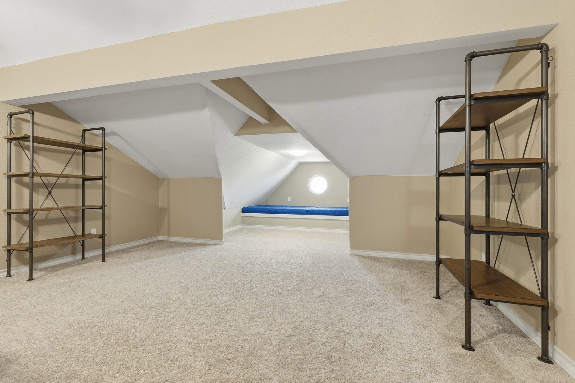 This versatile upper-floor bonus area offers endless possibilitiesfrom a music room or private office to a hobby or fitness space. Plush carpeting and architectural angles create a warm, inviting setting perfect for relaxation or hosting.