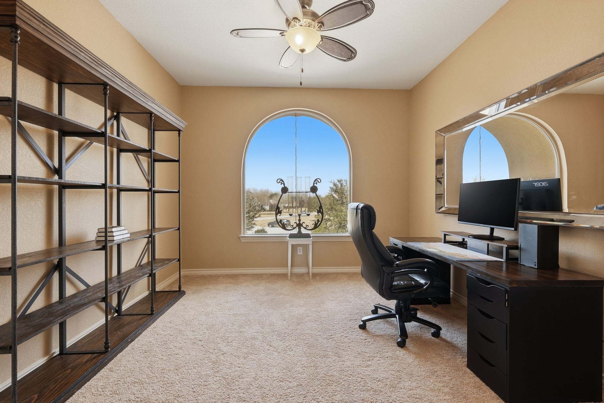 Situated upstairs for added privacy, this versatile office offers a quiet and refined workspace enhanced by an elegant arched window that fills the room with natural light. French doors add architectural charm while providing separation when desired. This flexible space can easily serve as an additional bedroom, media room, or playroom to suit your lifestyle needs.