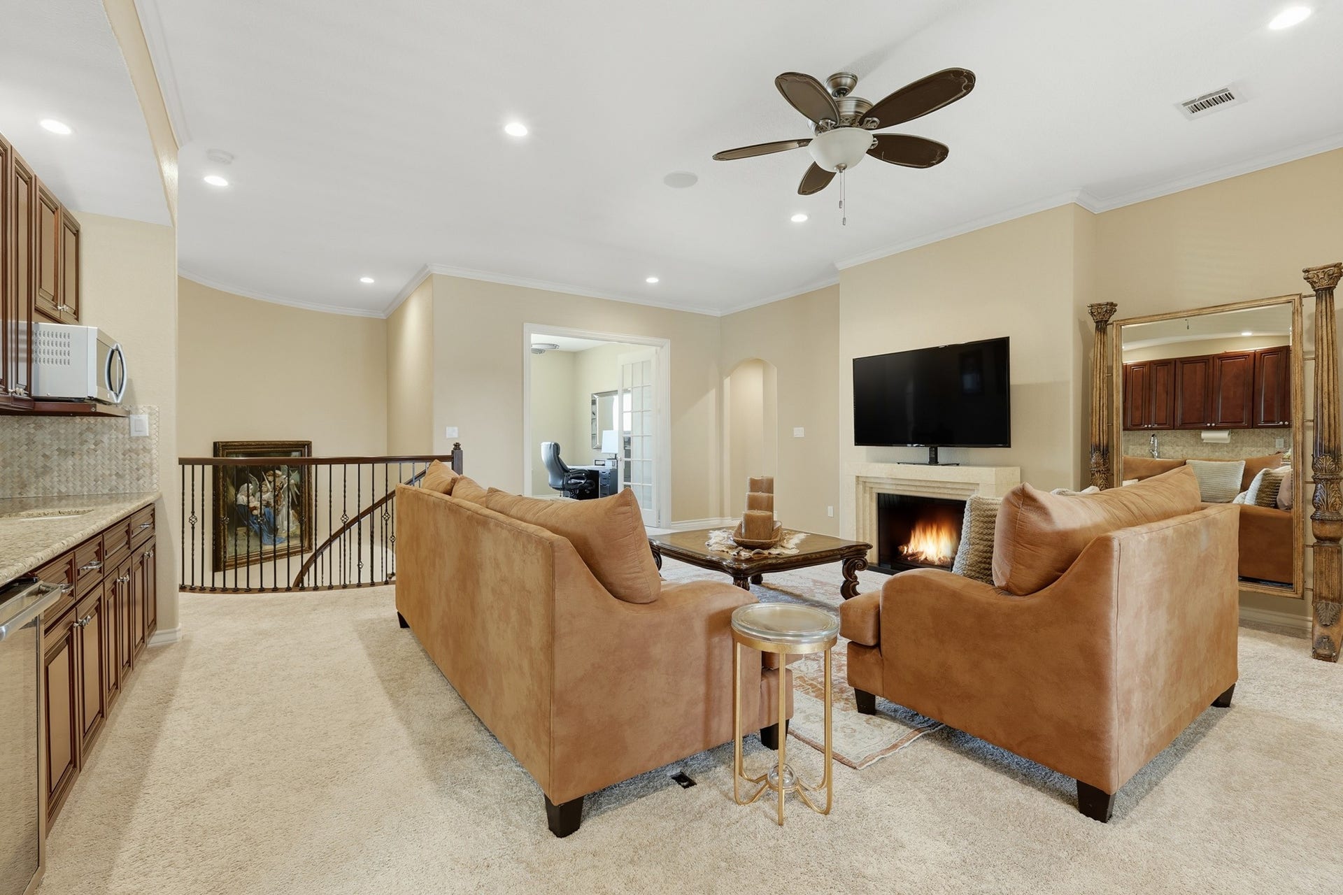 Elevating the homes versatility, this expansive upstairs living area offers a refined retreat ideal for a game room, media lounge, or theater space. An open layout, plush carpeting, recessed lighting, and elegant crown molding create a warm and inviting atmosphere.