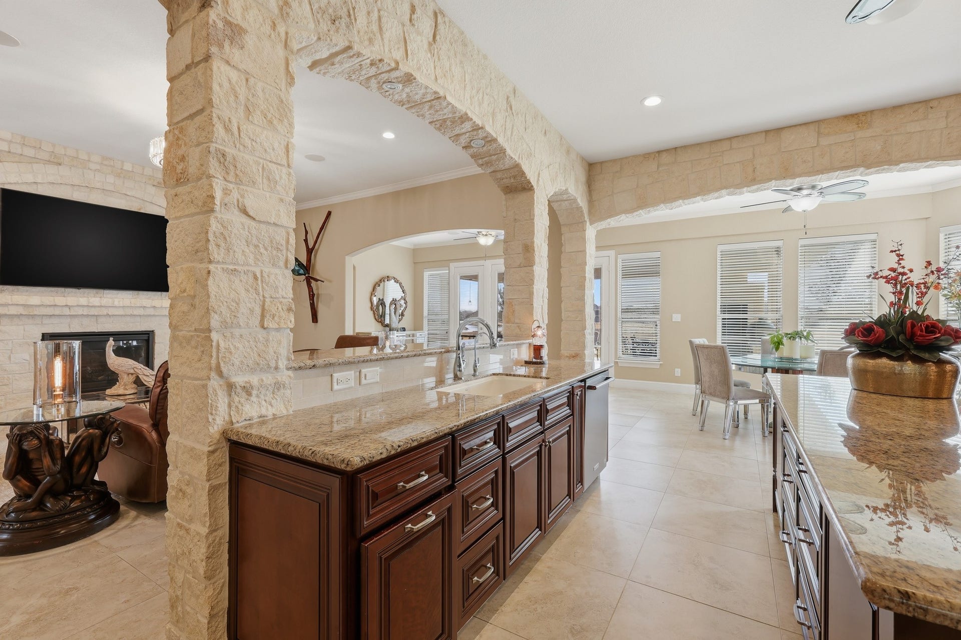 This open-concept kitchen flows seamlessly into the living space. Dual sinks, abundant cabinetry, and premium finishes ensure both convenience and beauty.