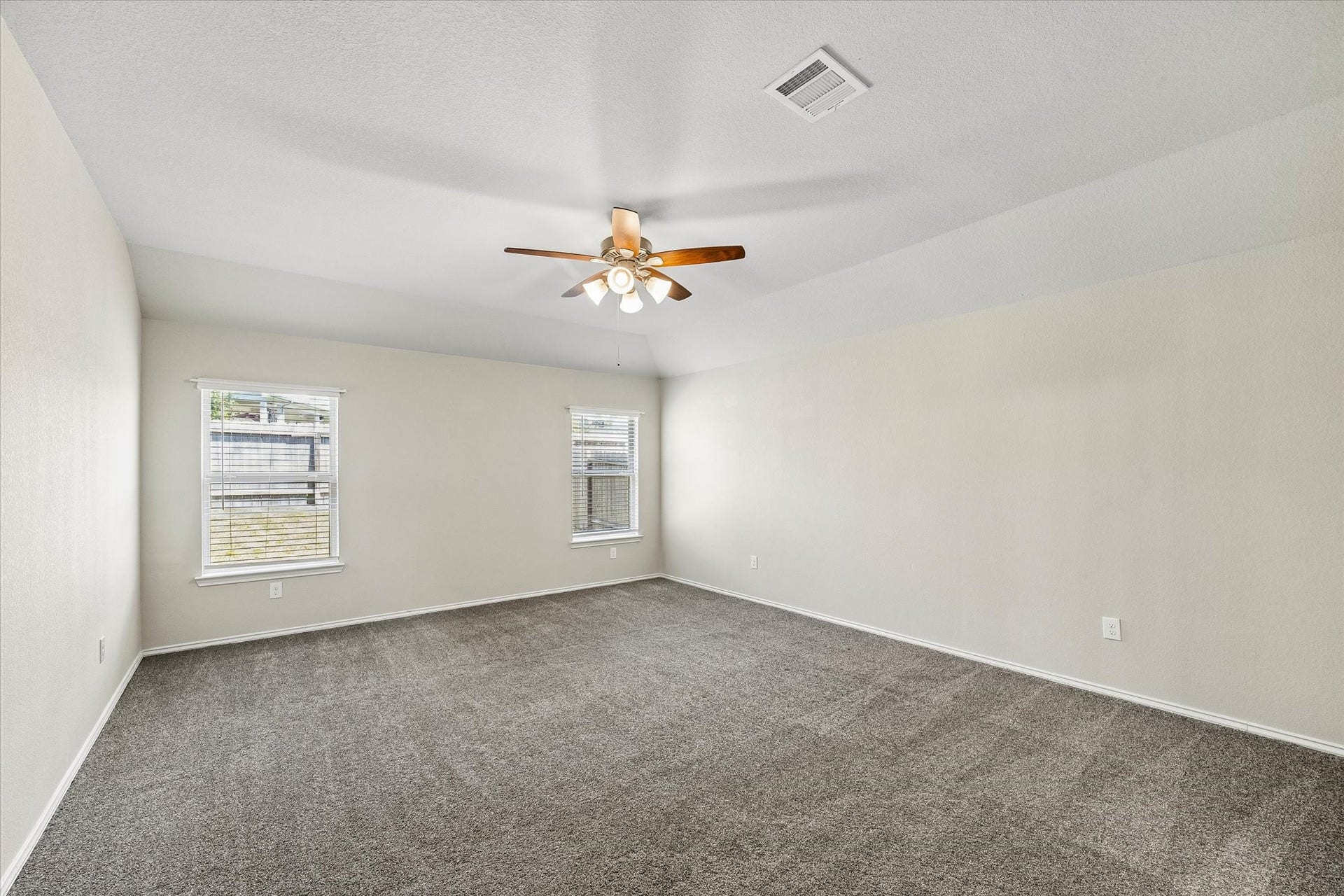 111 Valiant Ridge Trail, Magnolia, TX 77354 The spacious primary bedroom offers a relaxing retreat with soft carpeting, natural light and a ceiling fan. Neutral tones provide a lovely backdrop for your personal style.