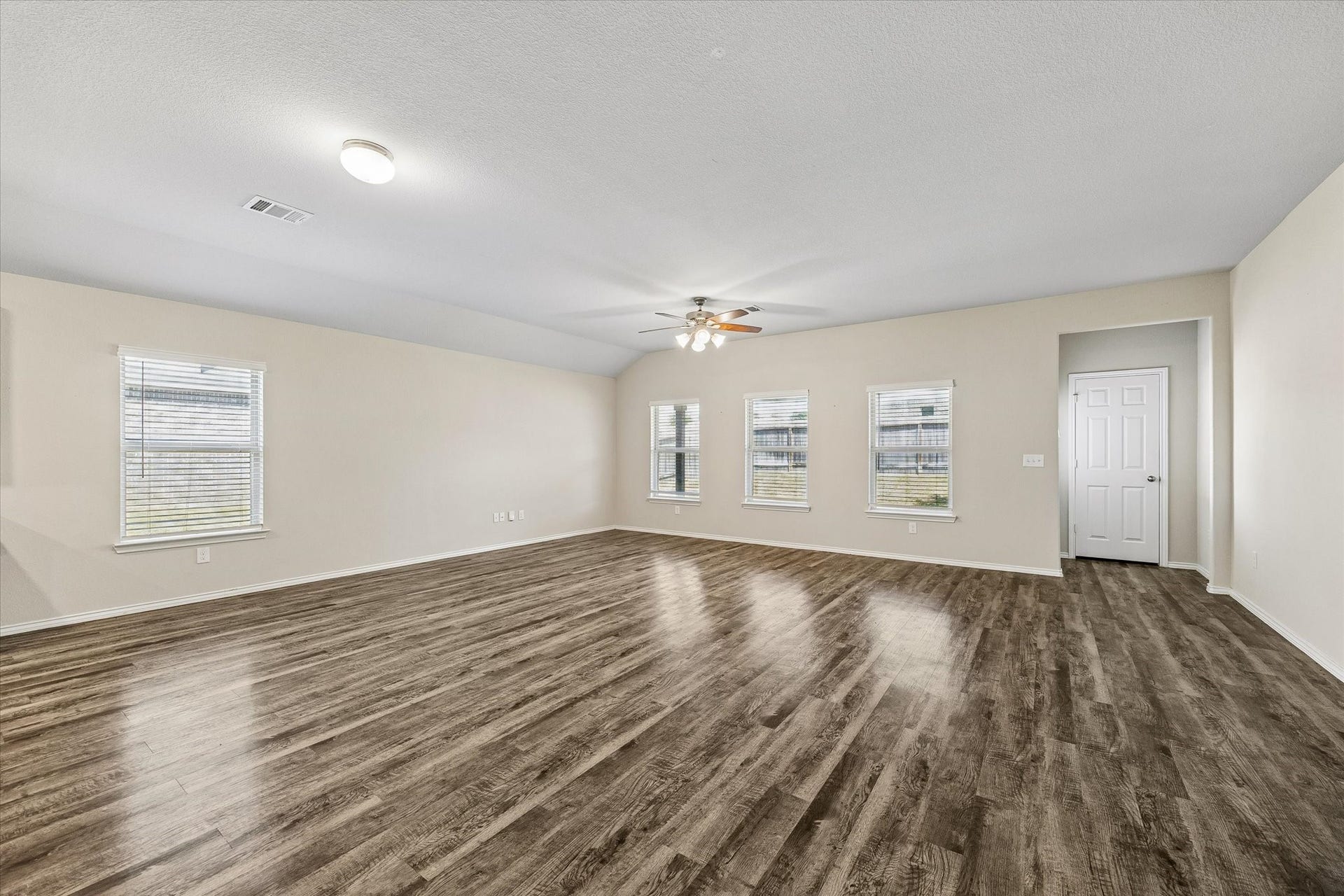 111 Valiant Ridge Trail, Magnolia, TX 77354 This expansive living and dining area offers plenty of room to arrange your favorite furnishings. Multiple windows welcome natural light, while a ceiling fan and recessed lighting complement the space.
