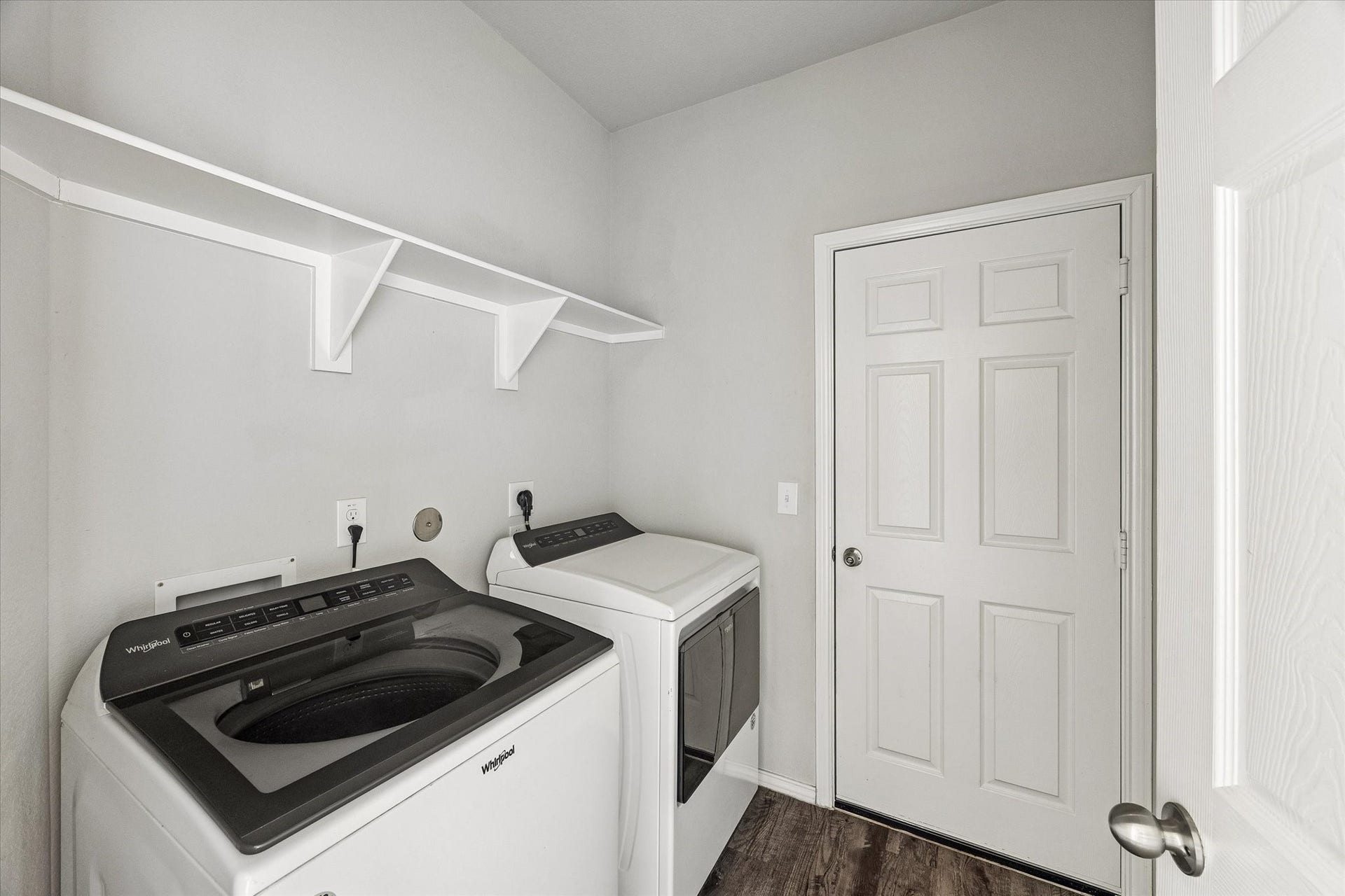 111 Valiant Ridge Trail, Magnolia, TX 77354 The dedicated laundry room offers space for a side-by-side washer and dryer, along with an overhead shelf and hanging rod to help keep laundry organized.