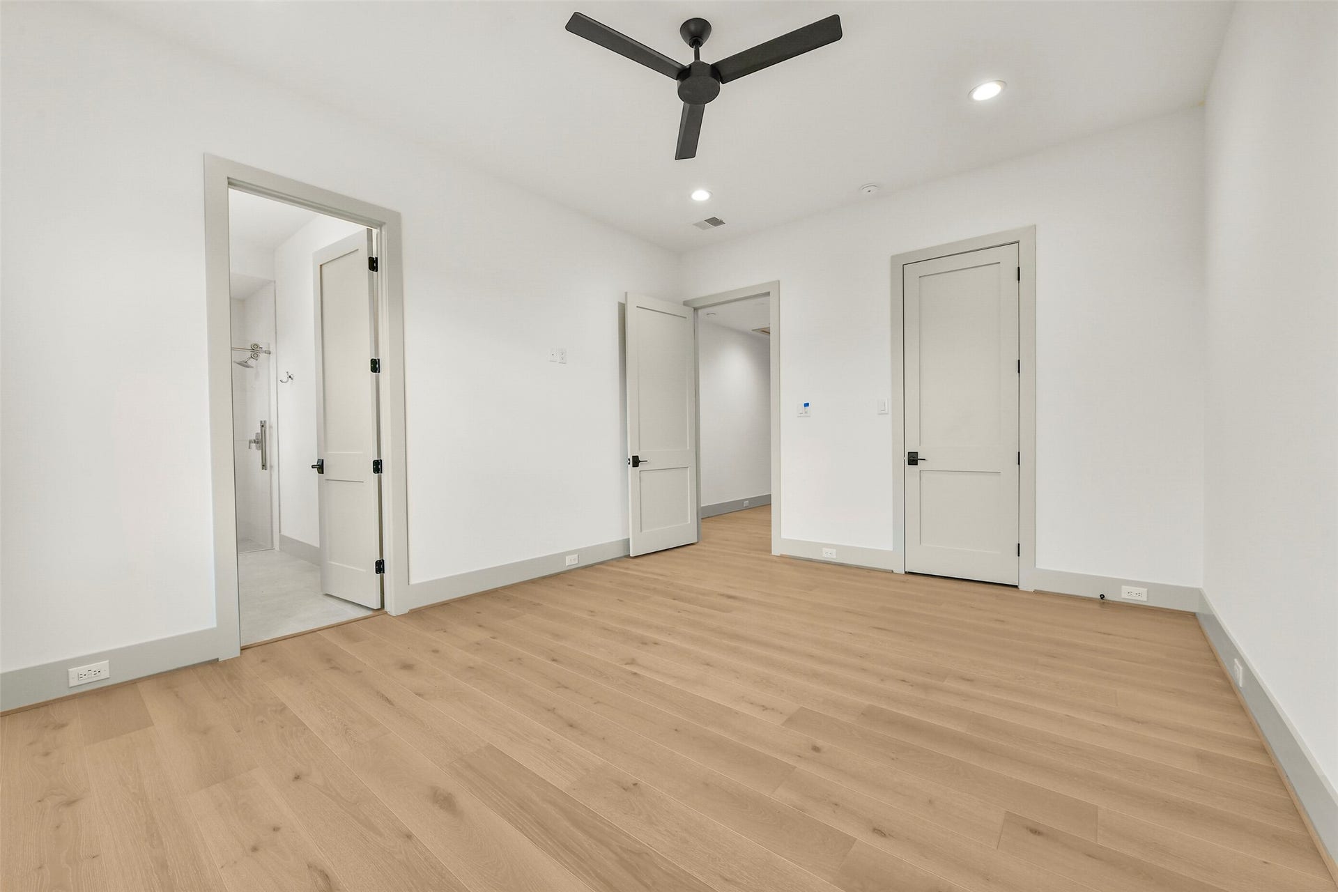 Another secondary bedroom with ensuite bath and walk-in closet. The white oak floors run throughout the home. There is no carpet in the home.