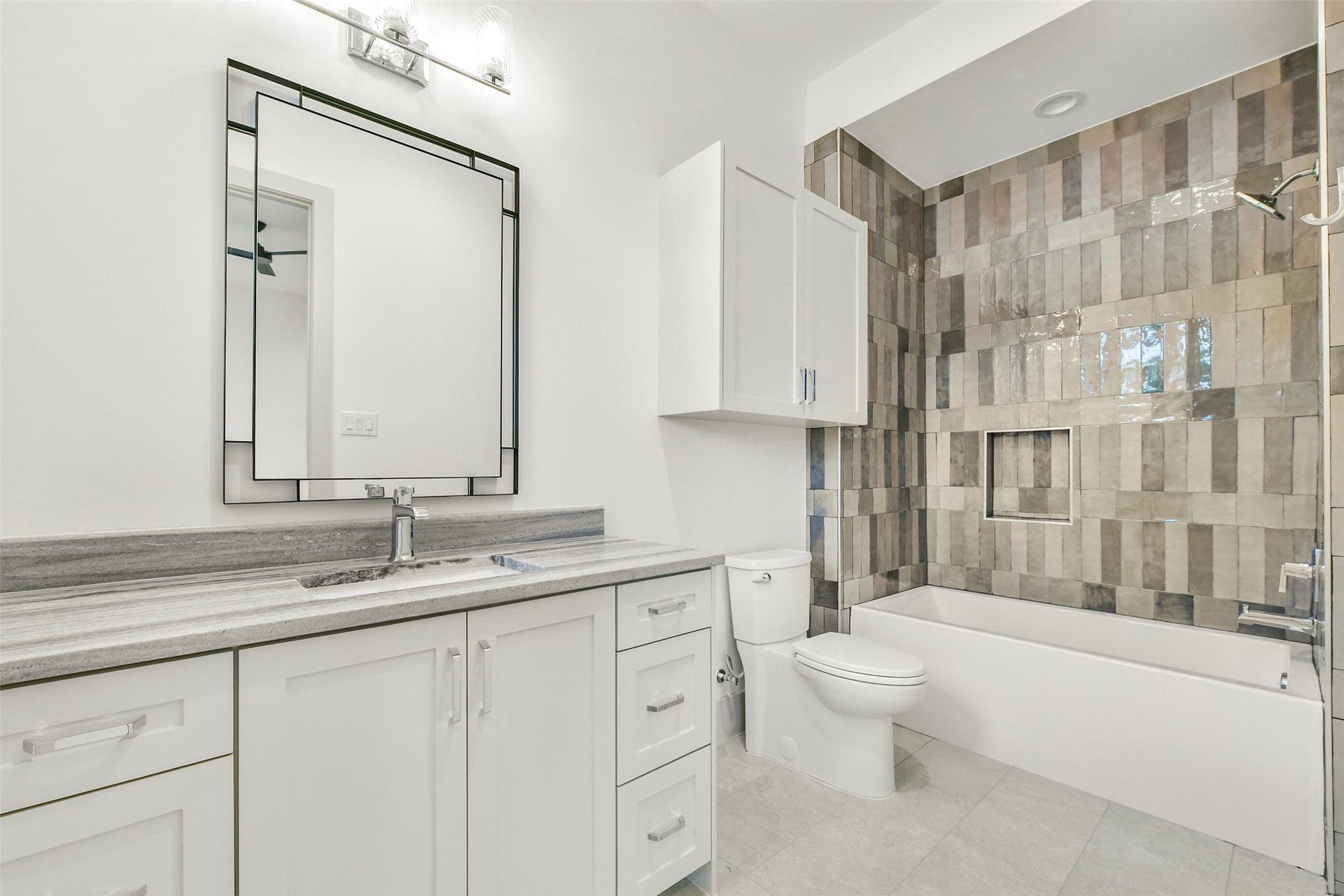 This secondary en-suite features an elegant tub-shower combination.