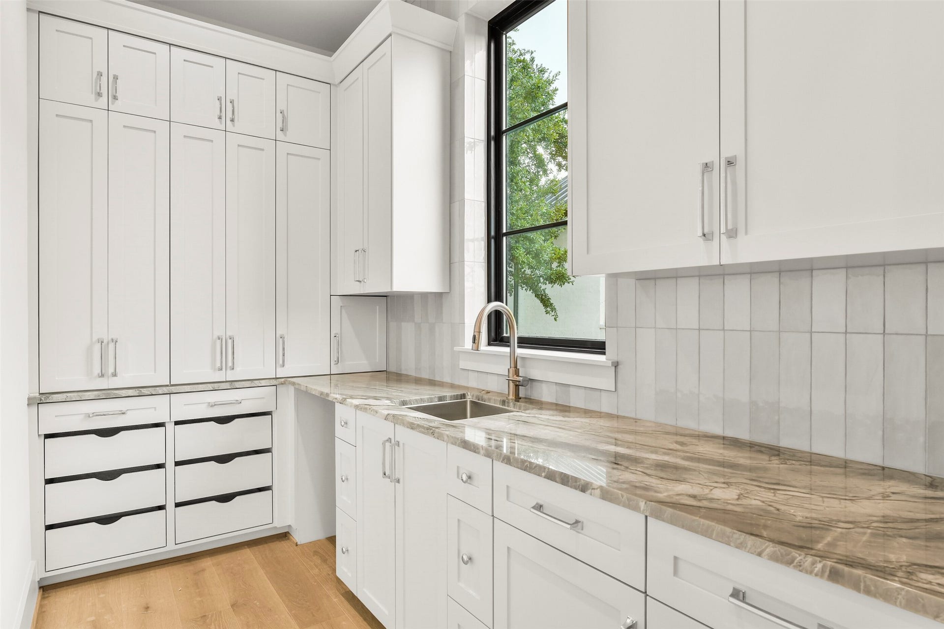 The Scullery Kitchen is perfect for preparation, serving and pantry storage. The open space can be used for an additional dishwasher, refrigerator or ice maker (All optional and customizable to the Buyer's needs)