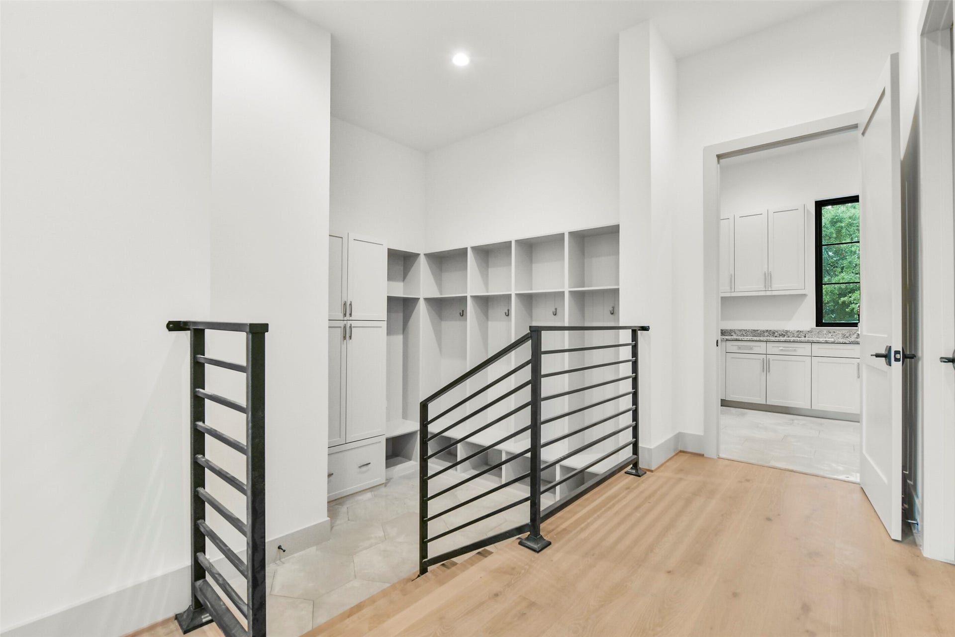 The mud room is at the entry from the garage and features built-in lockers and storage for the perfect drop zone before reaching the Elevator, utility, powder room, and main living spaces of the home.