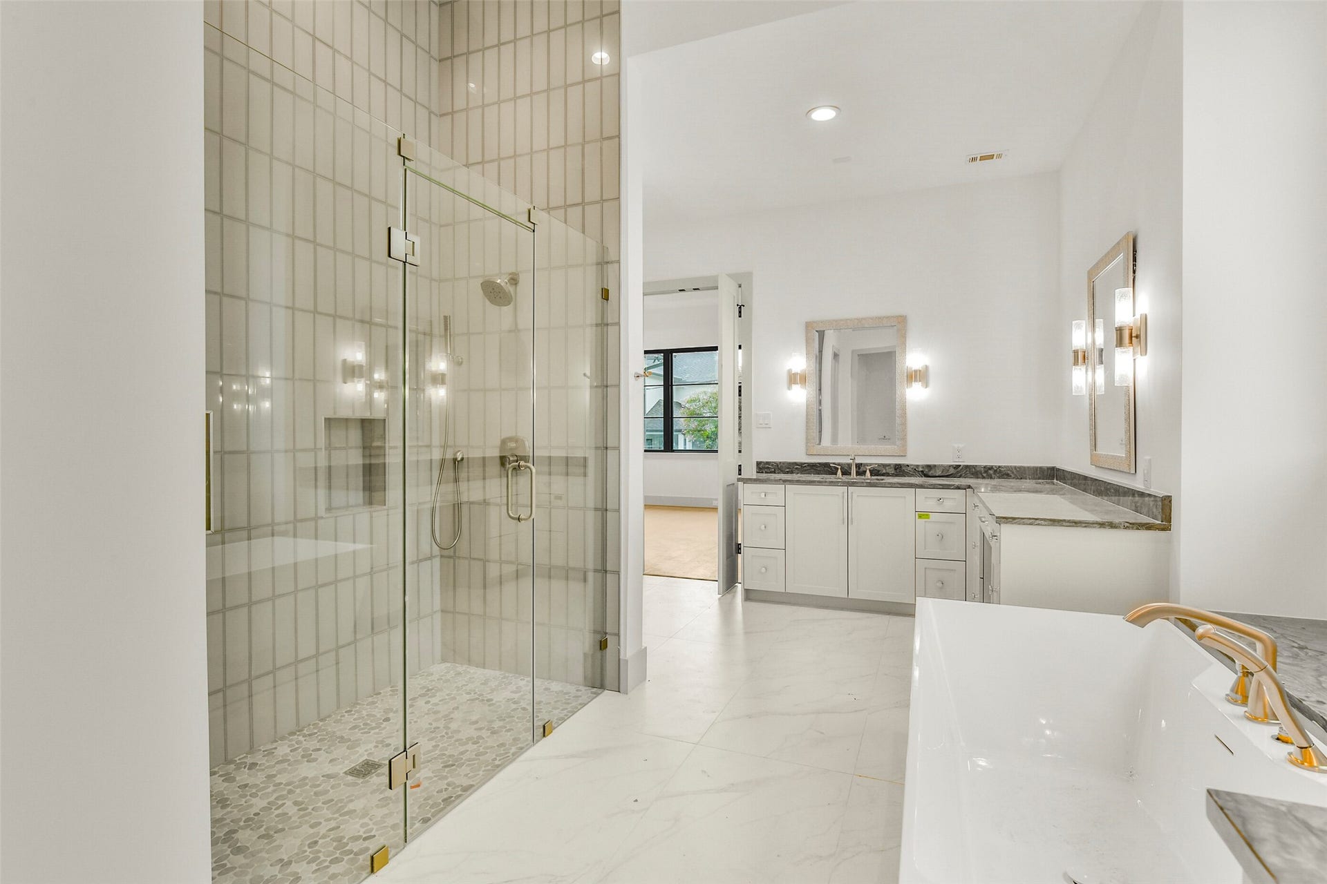 A closer look of the spacious walk-in shower refined tile surrounding and luxurious vessel tub.