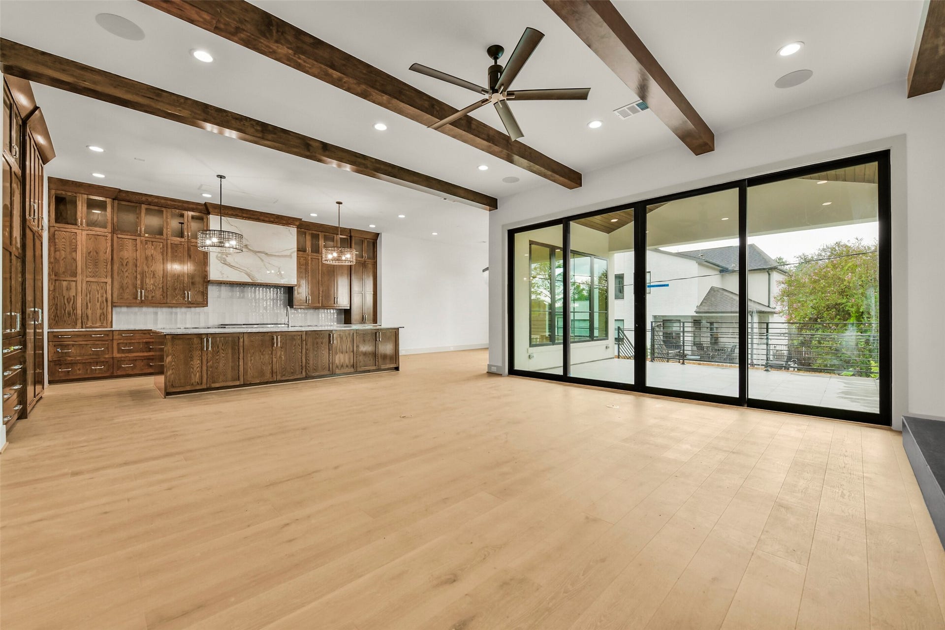 The heart of the home where guests and family will gather between the family room, kitchen, dining room and wet bar. Each elegantly appointed with custom cabinets, beamed ceilings and finishes curated by Steve Clifton of Scene One Interiors.