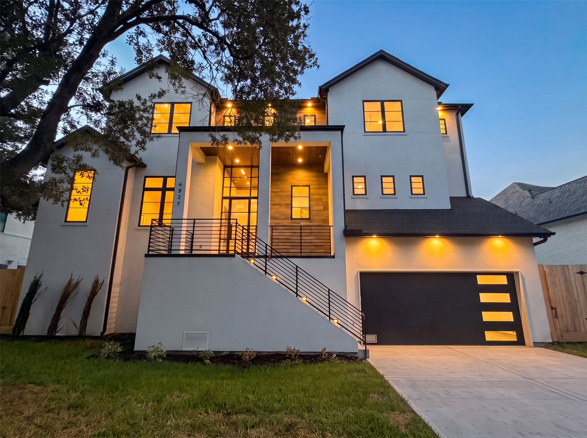 Spectacular Meyerland New Construction. The elegant facade features a combination of stucco and tile. The generous front porch has stained wood ceilings which flow into the entry foyer.