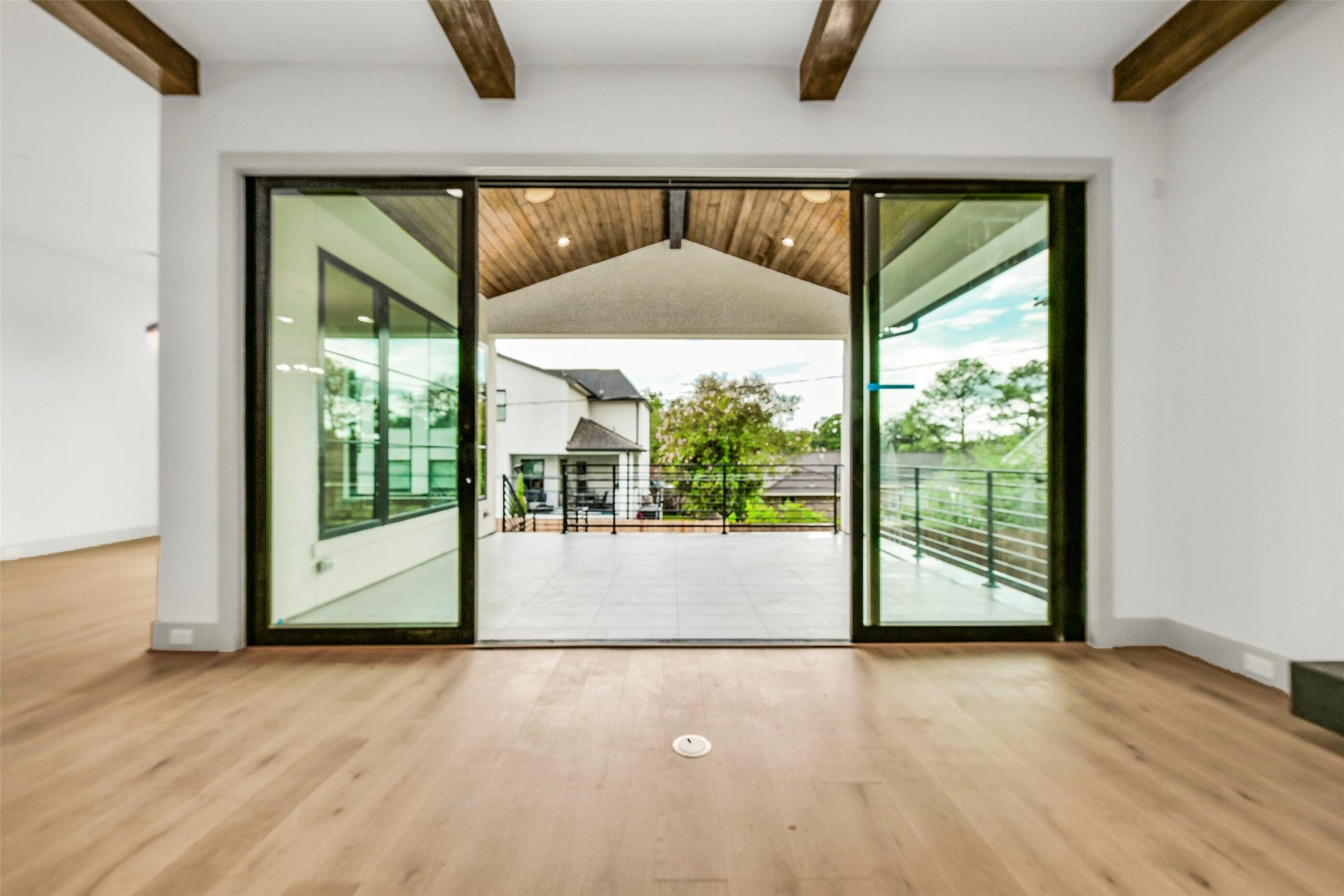 Step out from the family room through Anderson double sliding doors to the veranda with wood cathedral ceiling and stairs to the large backyard and 1400 square foot covered outdoor living space.