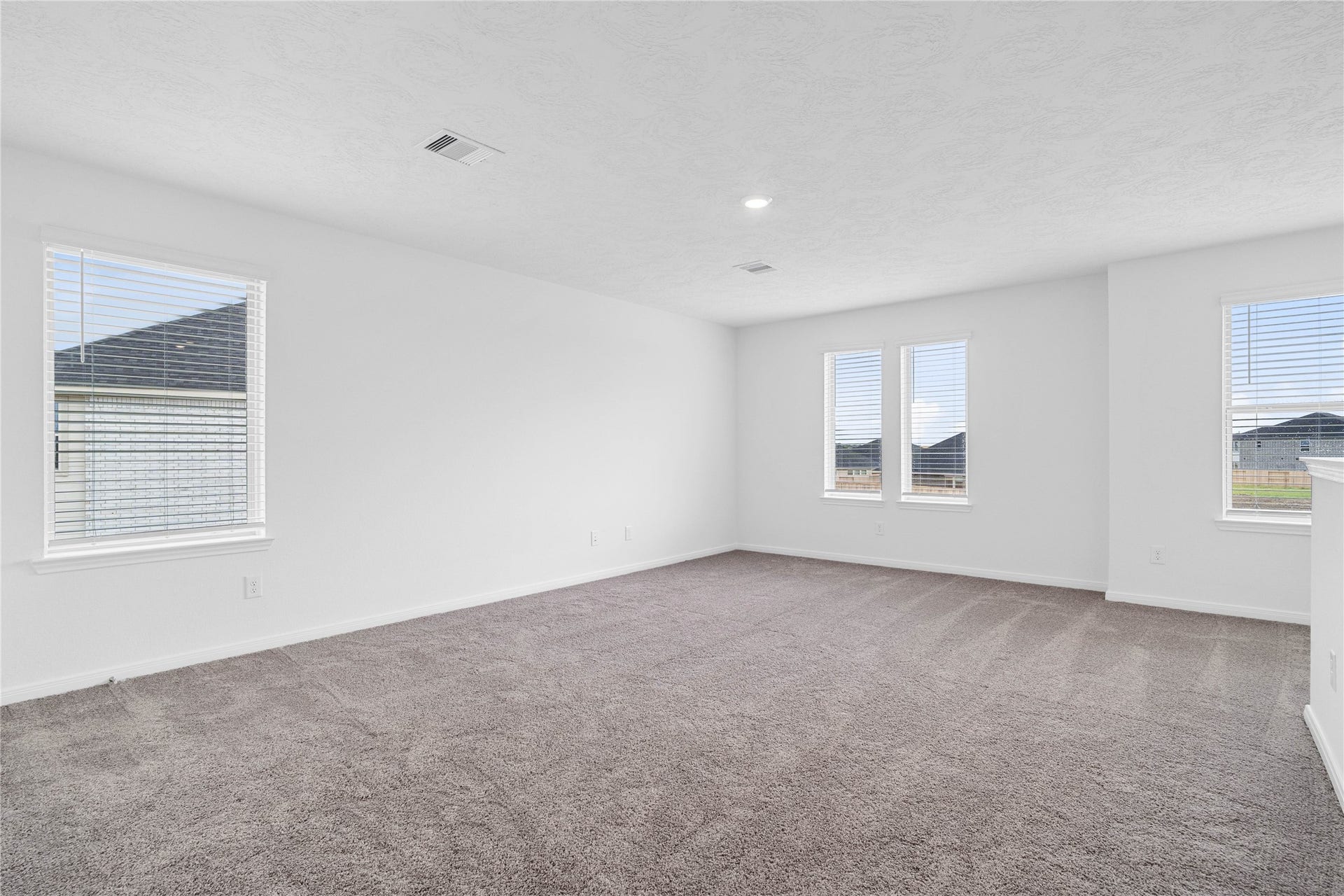 Head upstairs and enjoy the Loftan additional living area perfect for a game room, media space, or a peaceful retreat. Featuring plush carpet flooring, neutral paint, high ceilings, recessed lighting, and windows with blinds.
