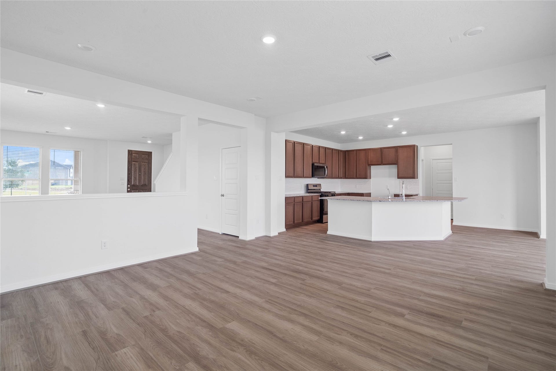 Stunning open-concept design seamlessly connecting the family, breakfast nook, and kitchen areasperfect for both everyday living and entertaining!