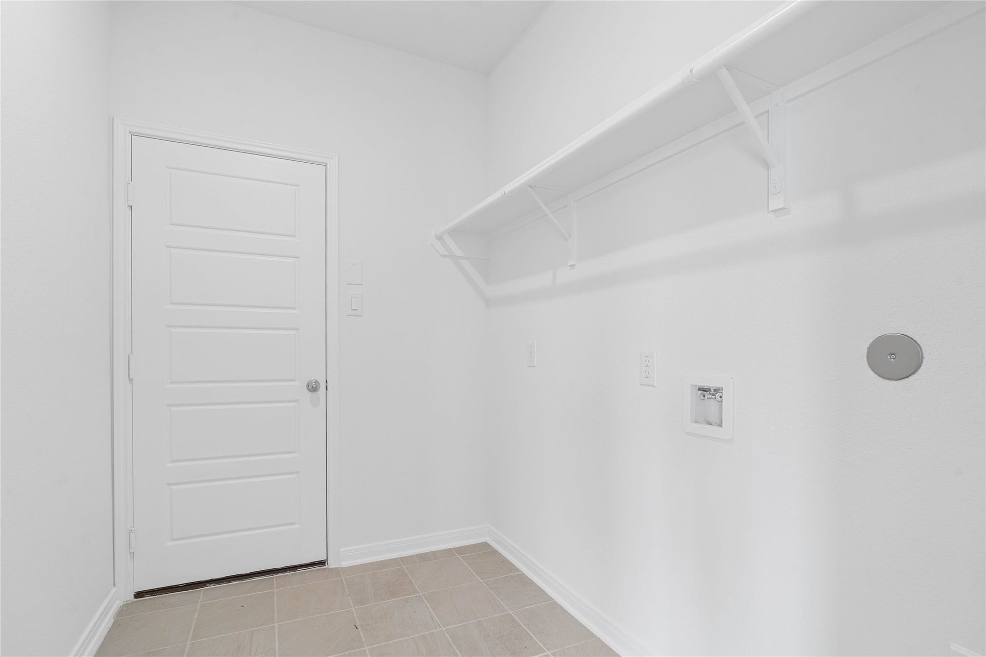 Laundry room conveniently located next to the garage.