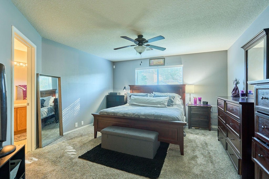 5934 Spring Sunrise Drive, Richmond, TX 77407 Your personal retreat! A spacious, relaxing bedroom with soft natural light and a soothing atmosphere.