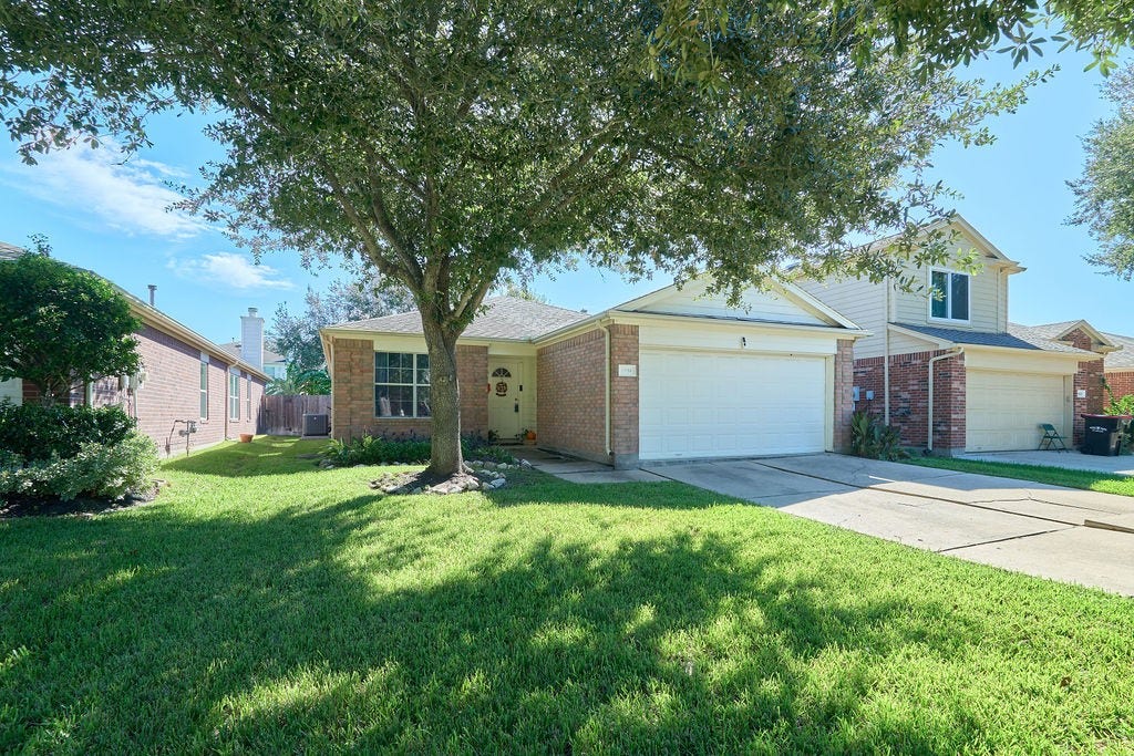 5934 Spring Sunrise Drive, Richmond, TX 77407 A picture-perfect welcome! Beautiful landscaping and a spacious front lawn enhance this home's inviting appeal.