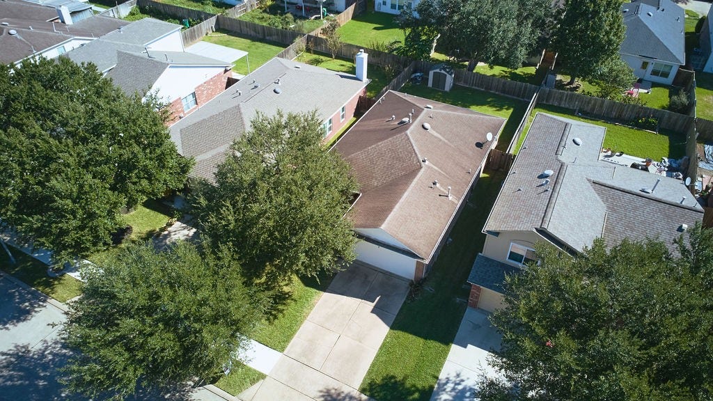 5934 Spring Sunrise Drive, Richmond, TX 77407 A bird's-eye perspective showcasing the home's setting, surrounding neighborhood, and established streetscape.
