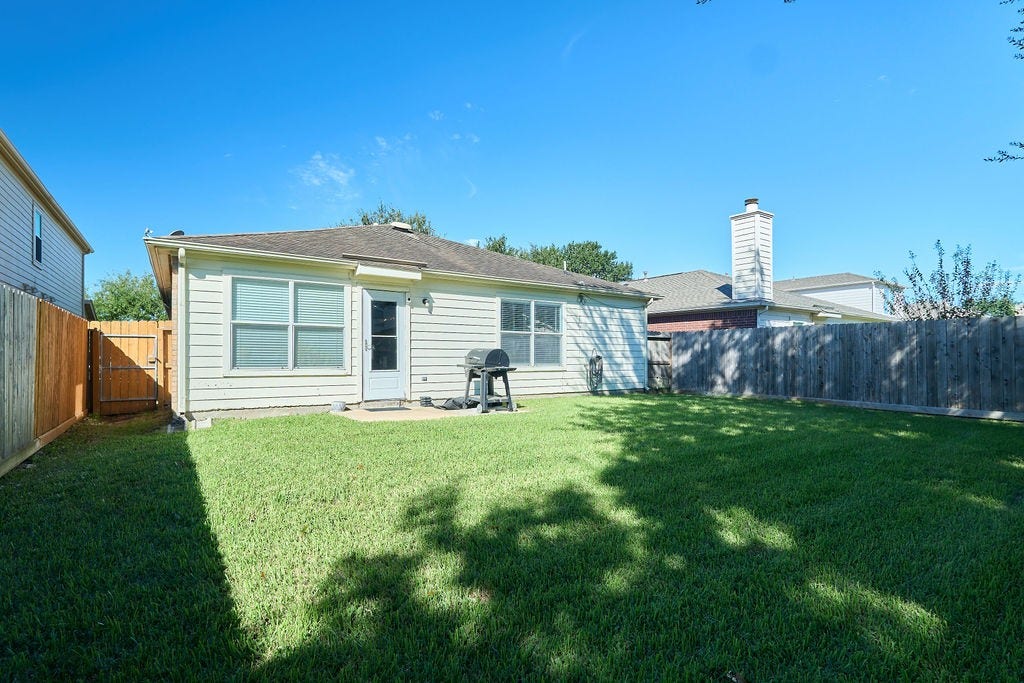5934 Spring Sunrise Drive, Richmond, TX 77407 Your outdoor escape awaits! Enjoy a spacious, fully fenced backyard with room for relaxation and recreation.