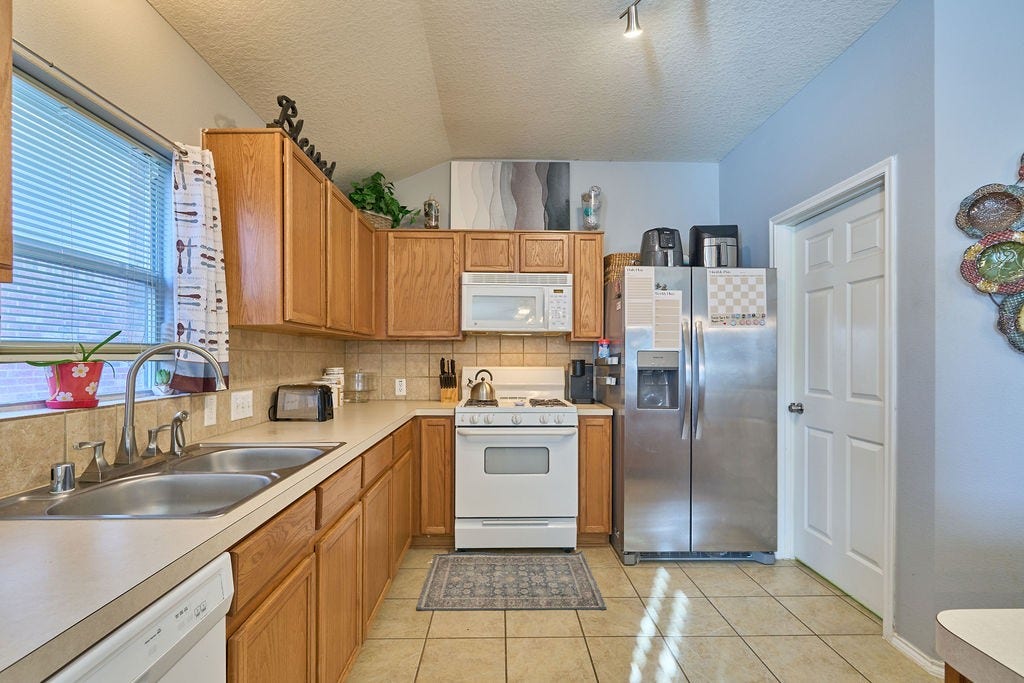 5934 Spring Sunrise Drive, Richmond, TX 77407 The heart of the home! A spacious kitchen featuring abundant cabinetry, generous countertops, and practical functionality.