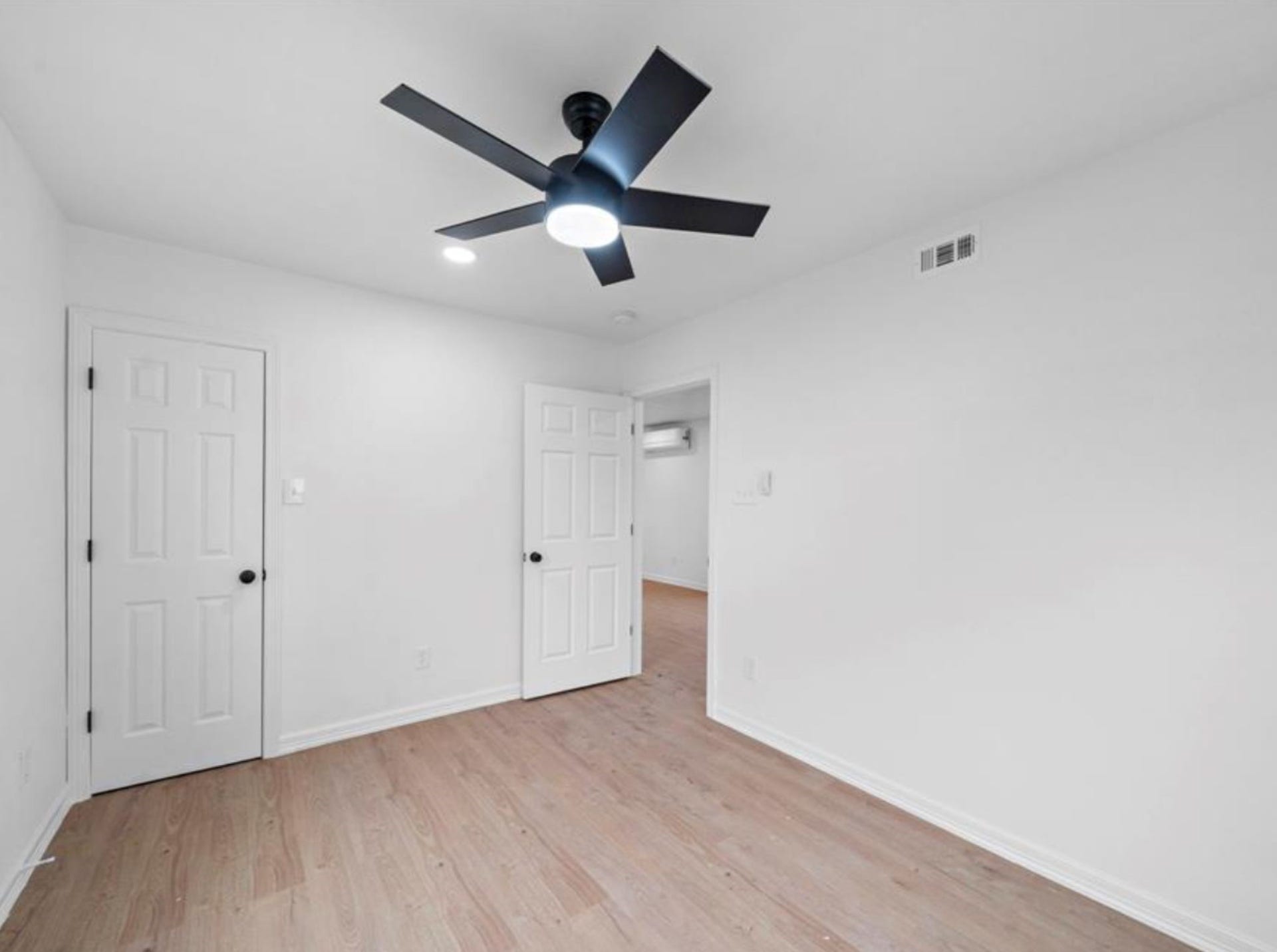 2312 Lucinda Street, Houston, TX 77004 Bedroom with closet storage and laminate flooring.