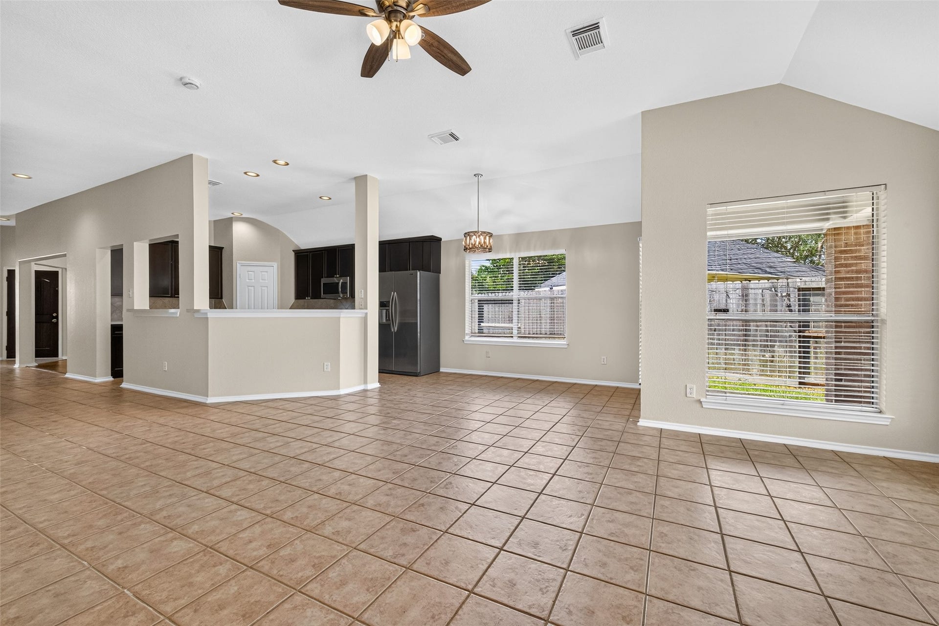 4903 Chappel Hill Drive, Missouri City, TX 77459 Living room view highlights the open-concept floor plan, seamlessly connecting the breakfast nook and kitchen area