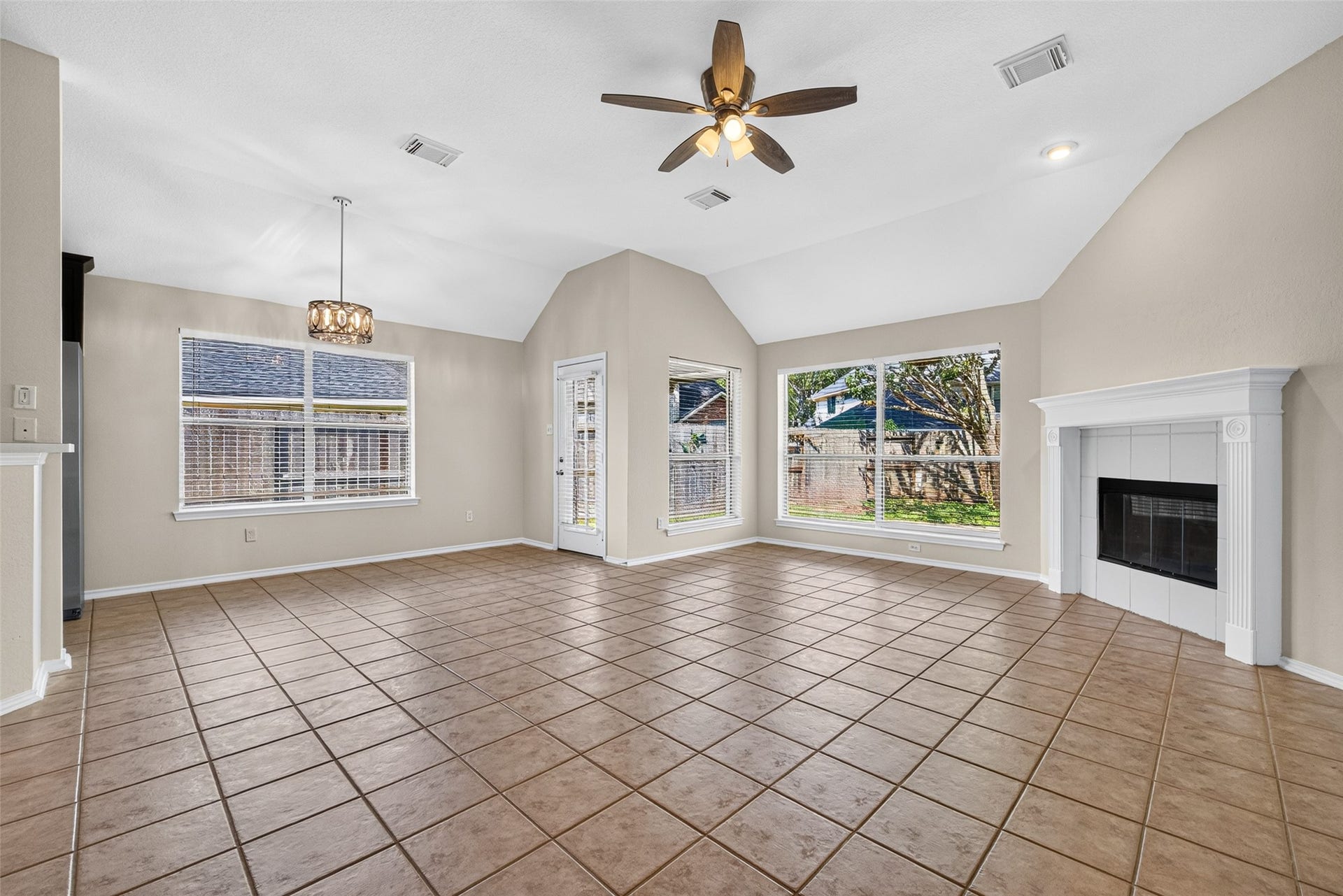 4903 Chappel Hill Drive, Missouri City, TX 77459 Spacious living room featuring an abundance of natural light, a cozy fireplace, and high ceilings