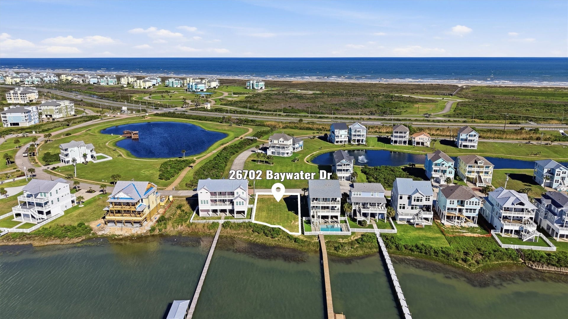 26702 Bay Water Drive, Galveston, TX 77554 This beautifully located lot backs to a scenic pond with fountains and a walking and jogging trail, adding a peaceful natural setting to your future custom home.