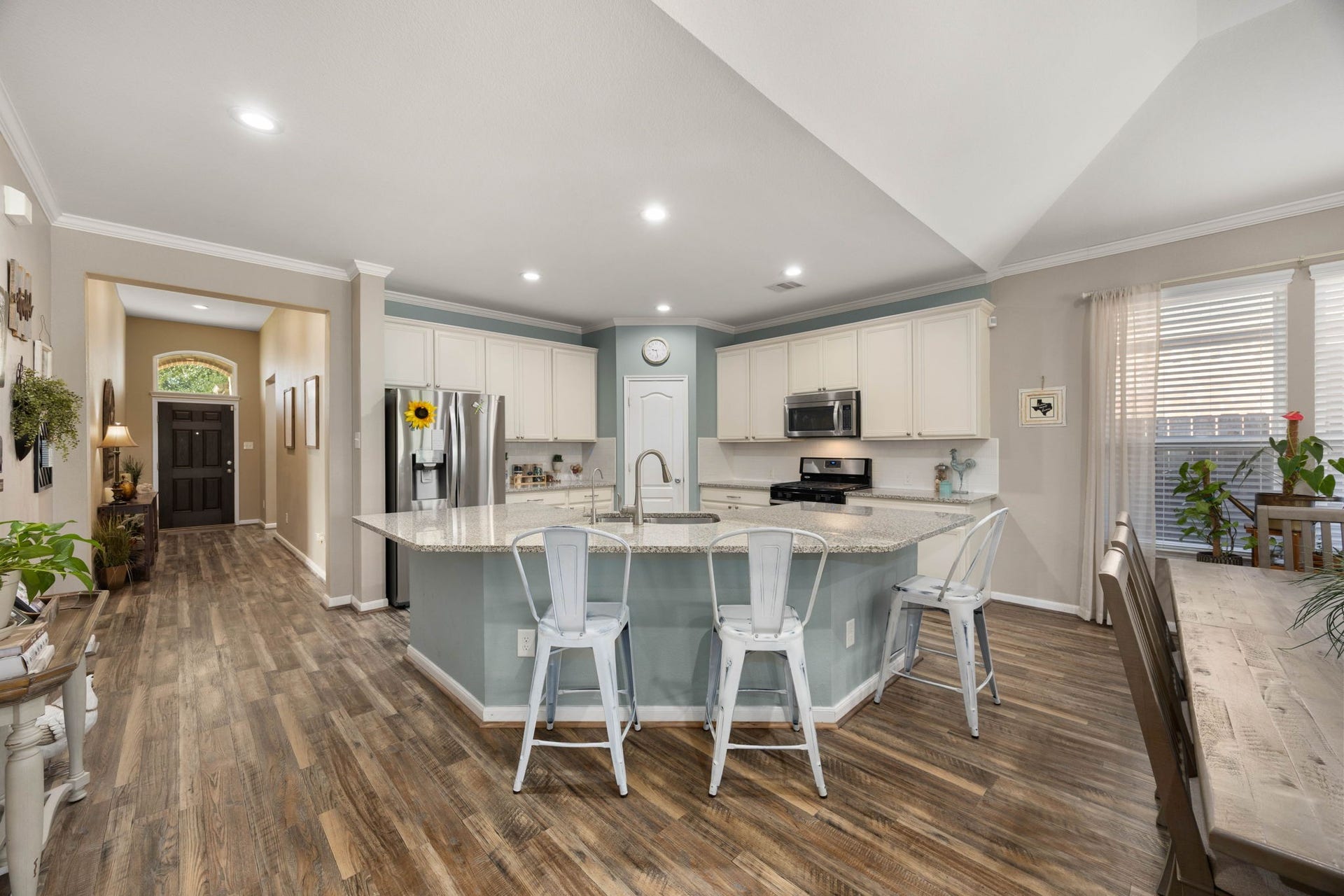 24114 Buffalo Cove Lane, Katy, TX 77493 A large granite island with breakfast bar seating anchors the kitchen, offering generous counter space for meal prep or casual dining.
